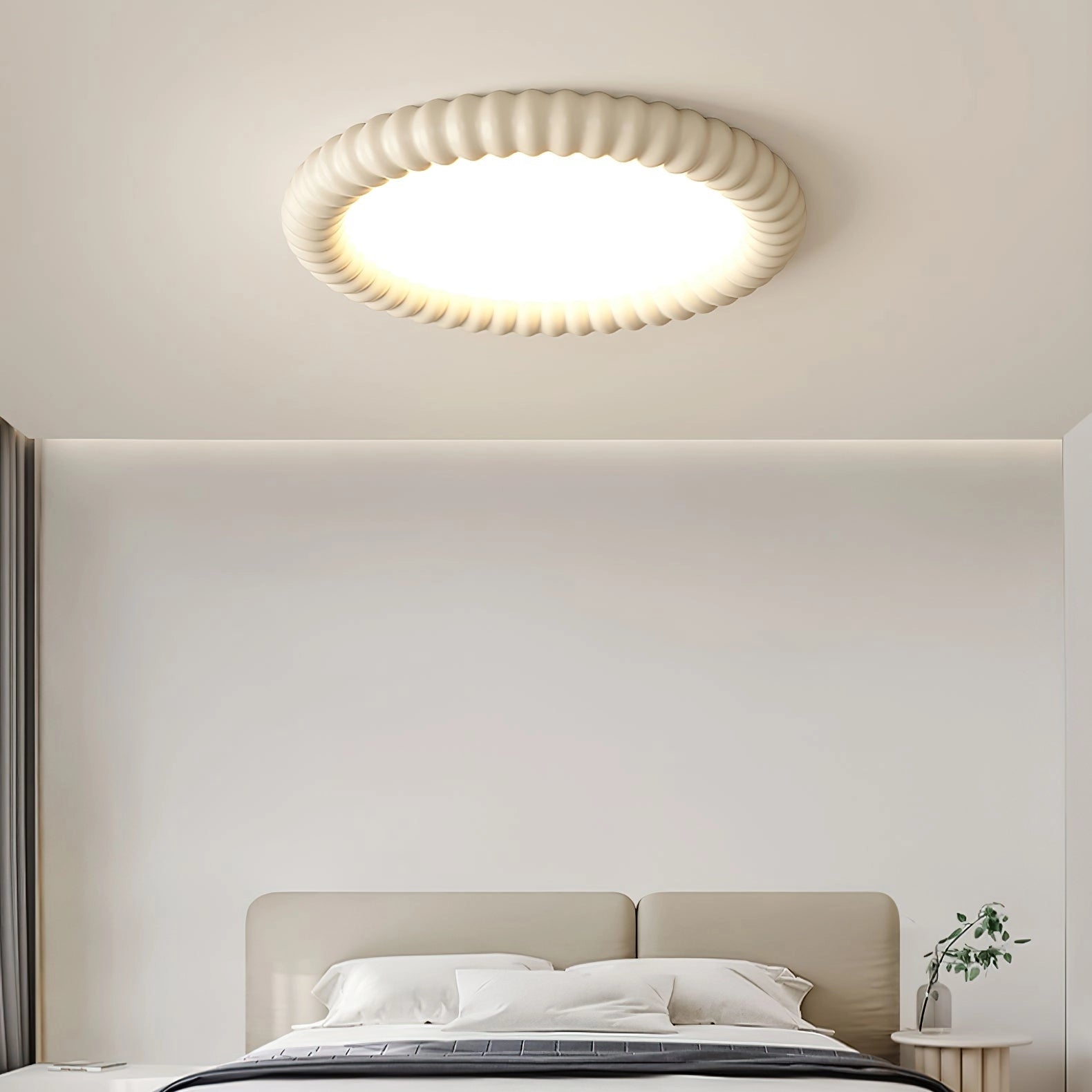Modern LED ceiling light installed on a white ceiling in a contemporary interior with wooden accents and grey walls, providing dimmable and energy-efficient lighting.