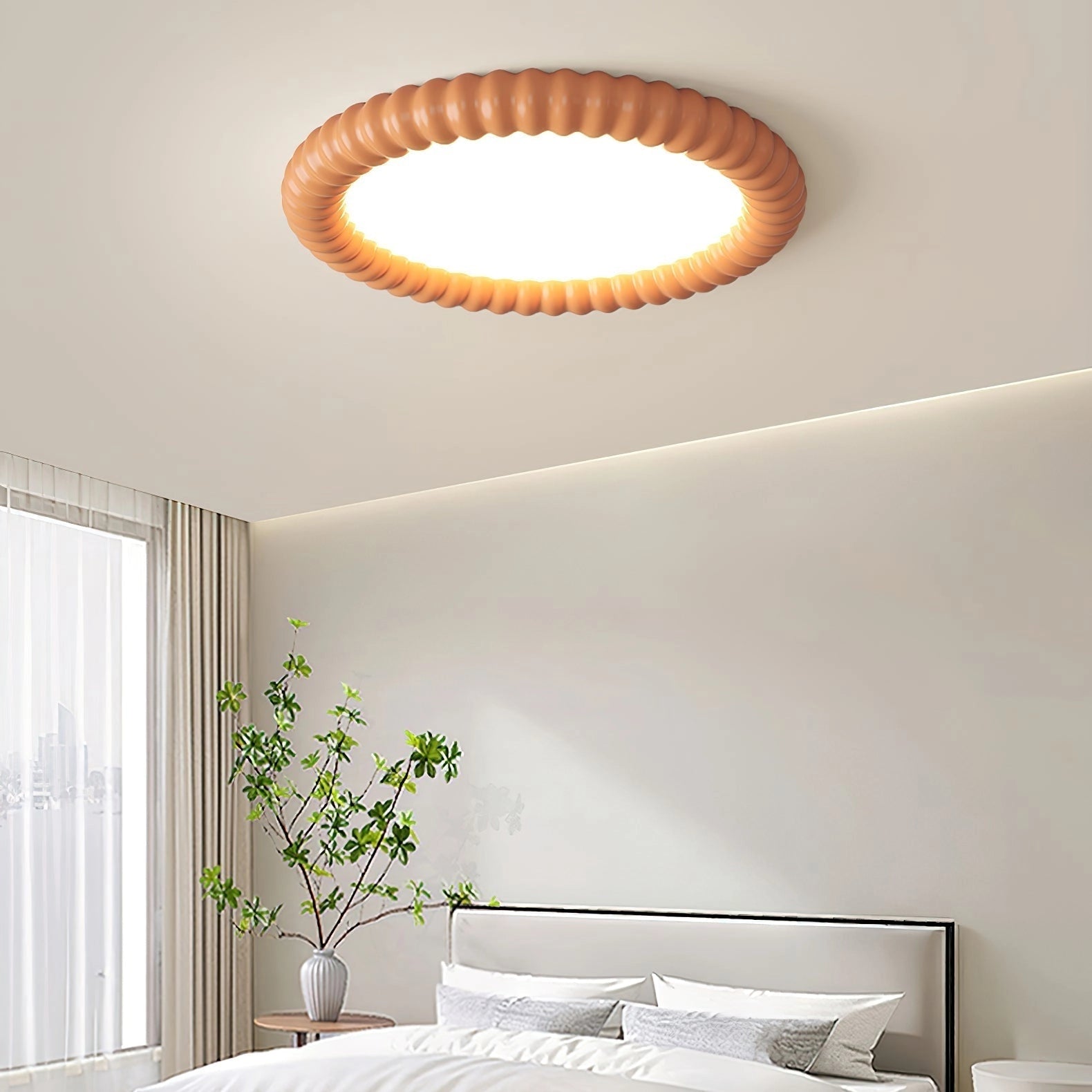 Modern LED ceiling light installed in a well-lit, stylish interior with houseplants and wooden elements.