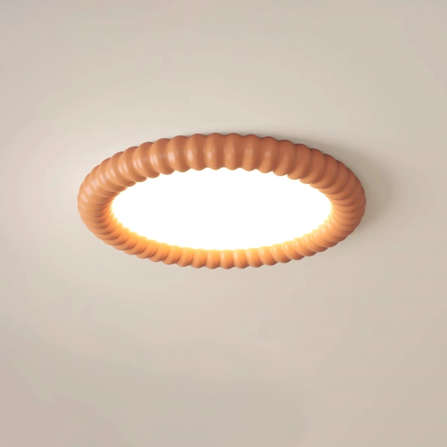 Modern LED ceiling light with an oval and circular design, emitting warm light in an orange hue, installed on a ceiling.