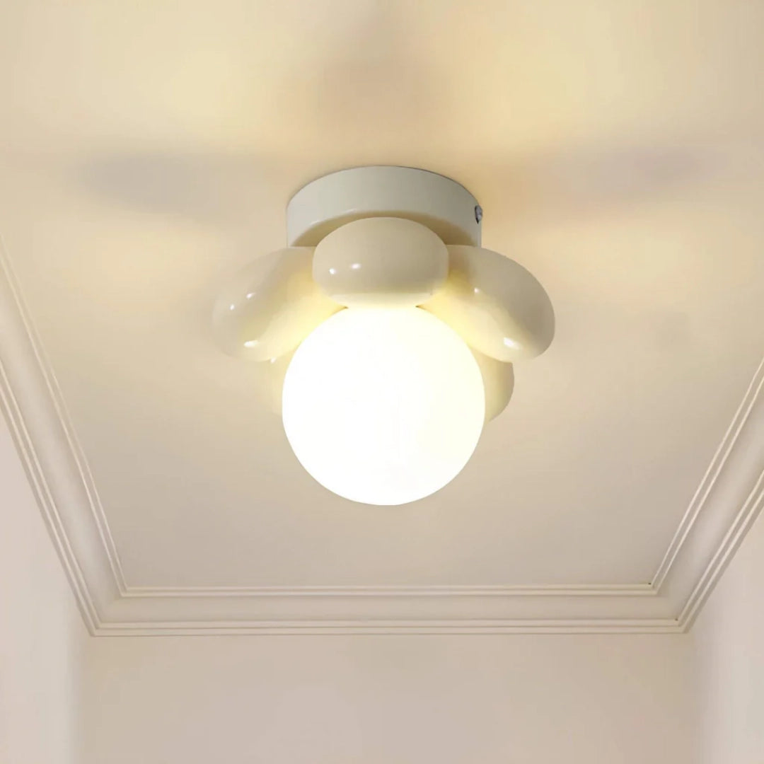 Modern minimalist round LED ceiling light with opal glass in a cream finish, flush-mounted to a smooth plaster ceiling.