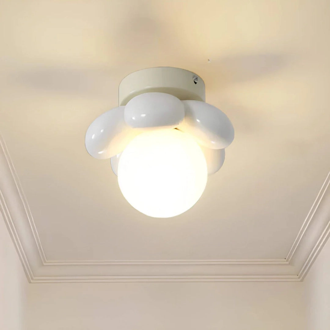 Modern LED ceiling light with a minimalist round flush mount design featuring opal glass and a white finish, installed on a ceiling.