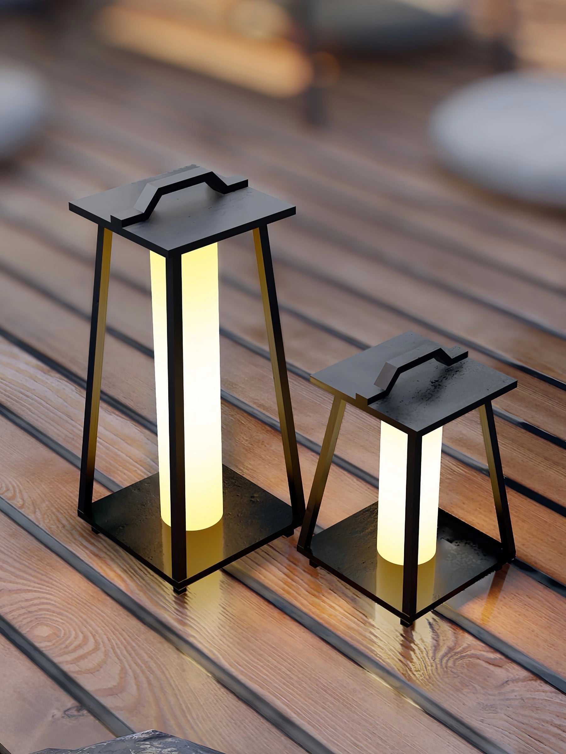 Modern LED outdoor lanterns with sleek minimalist design placed on a wooden outdoor table.