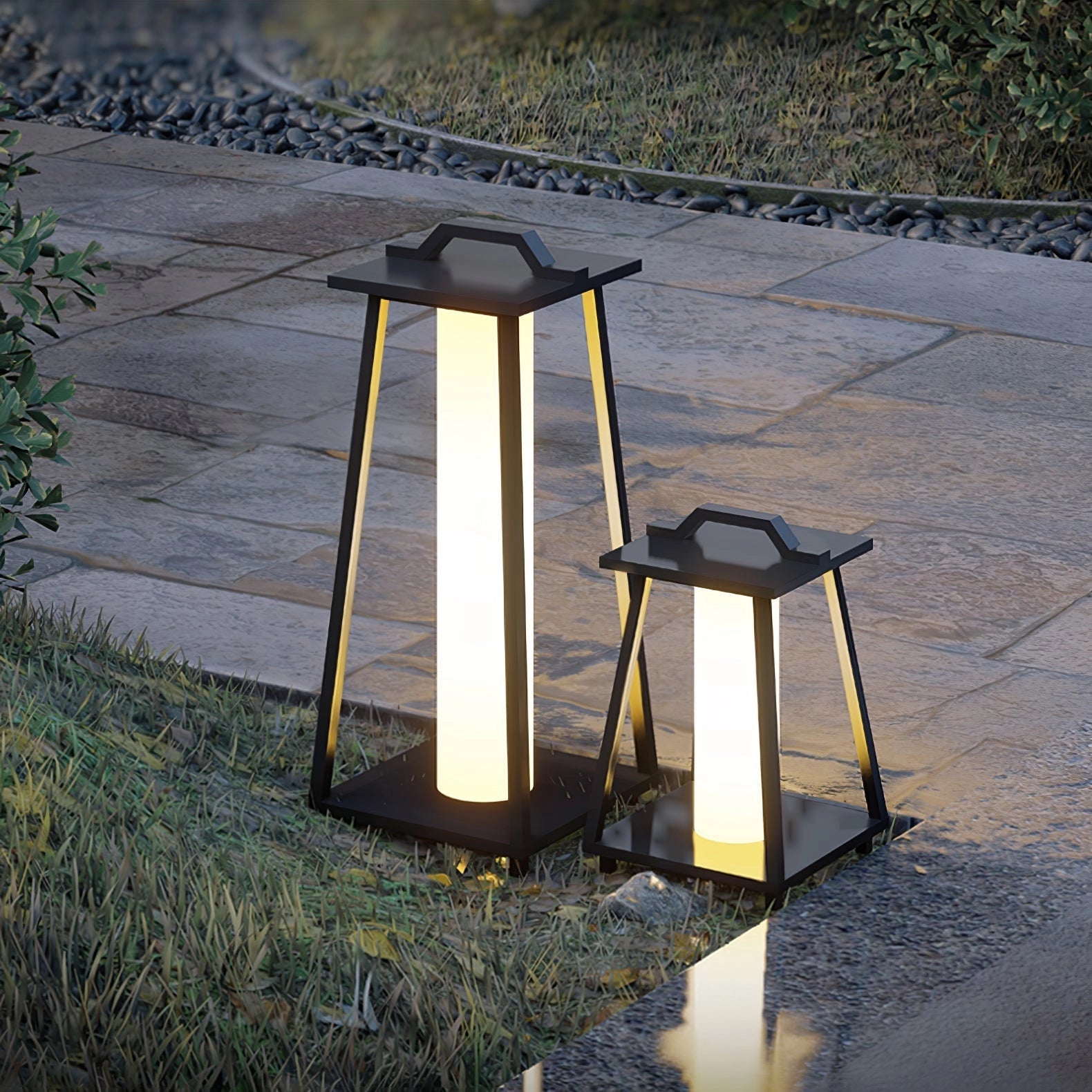 Modern LED outdoor lanterns illuminating a stylish patio area with wooden decking, surrounded by plants and greenery, under sunlight.