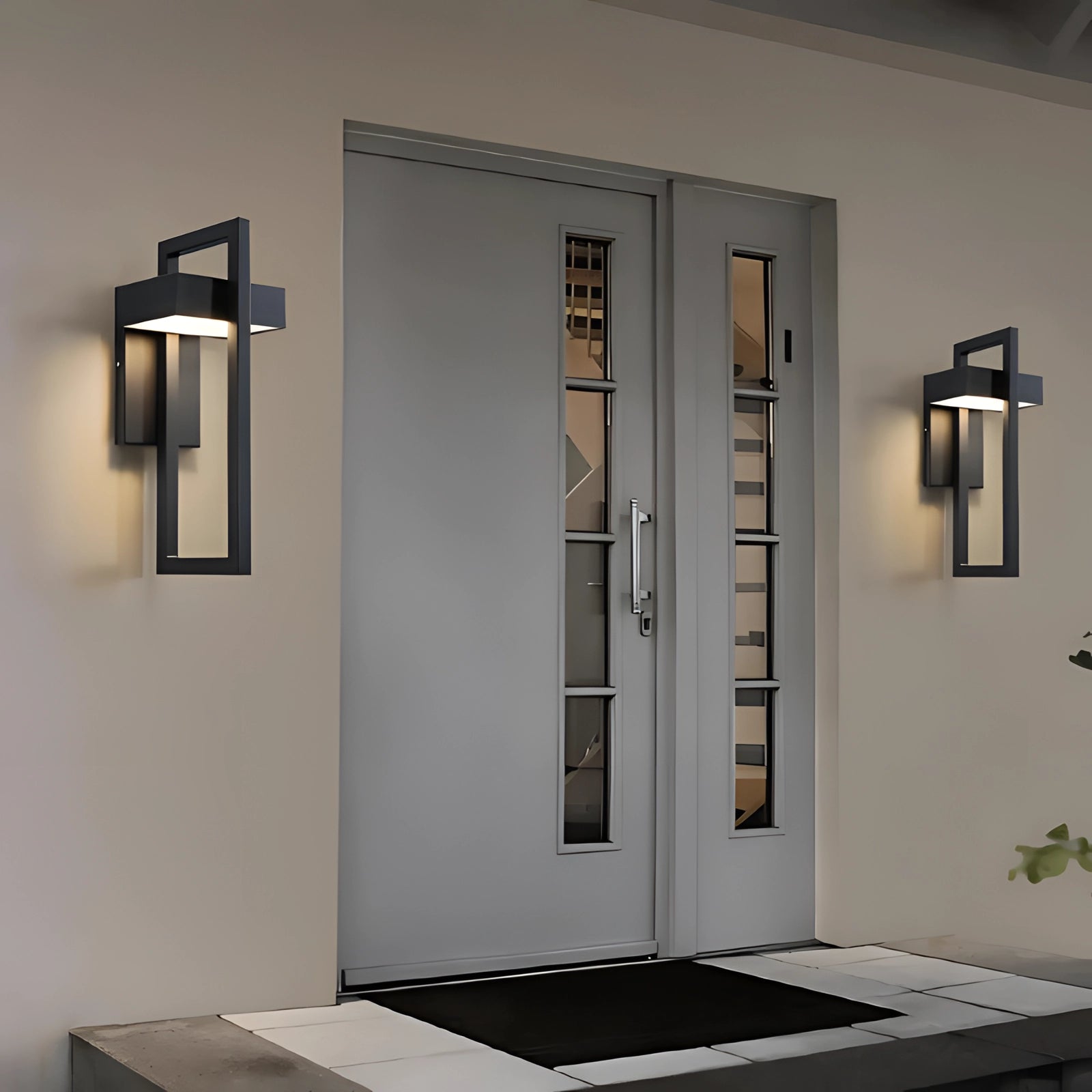 Modern LED outdoor wall light fixture mounted on a wooden exterior wall near a door, illuminating the entrance with a sleek, rectangular design.