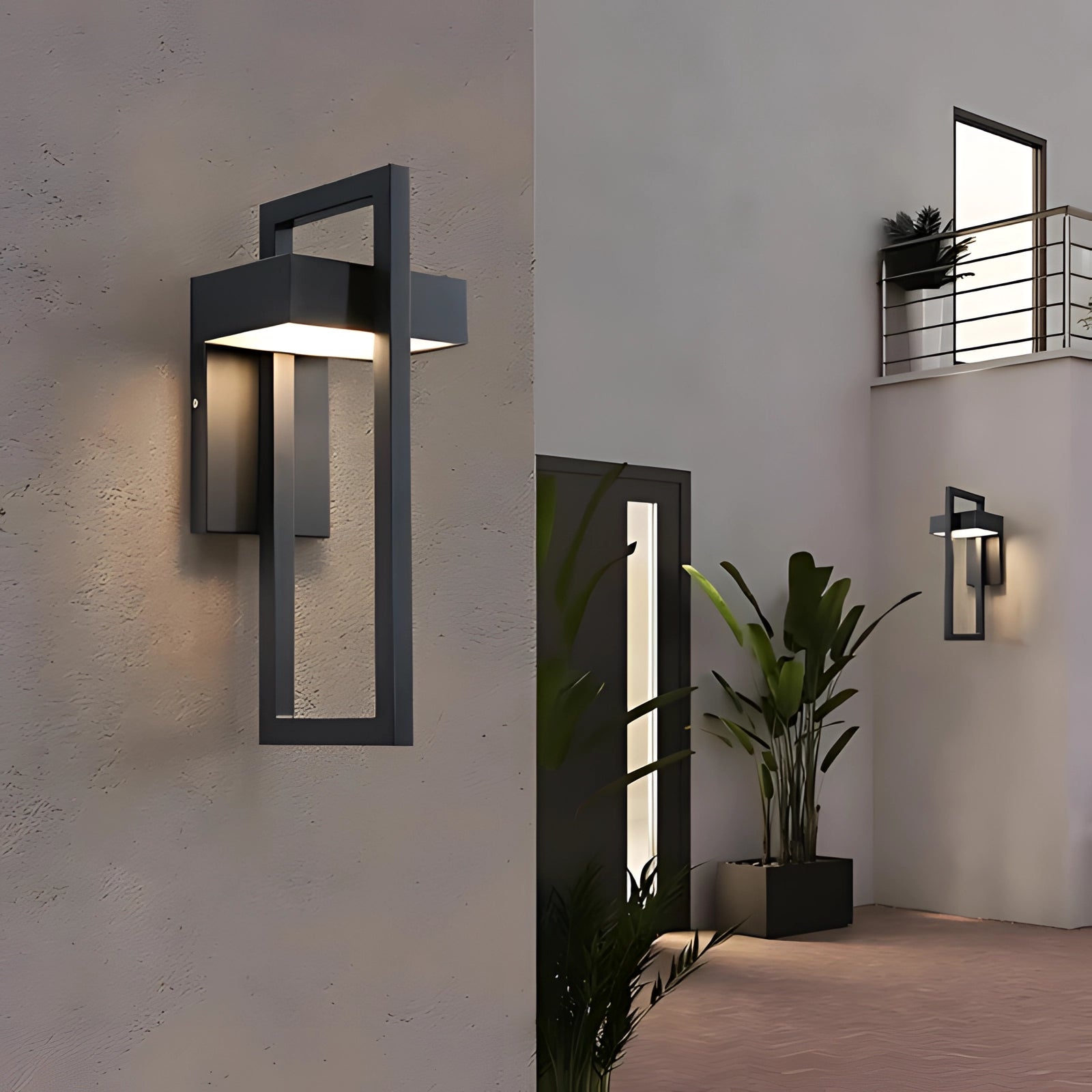 Modern LED outdoor wall light mounted on the facade of a building, with a sleek rectangular design. The light fixture is surrounded by potted plants and wooden elements, highlighting its weather-resistant and energy-efficient features.