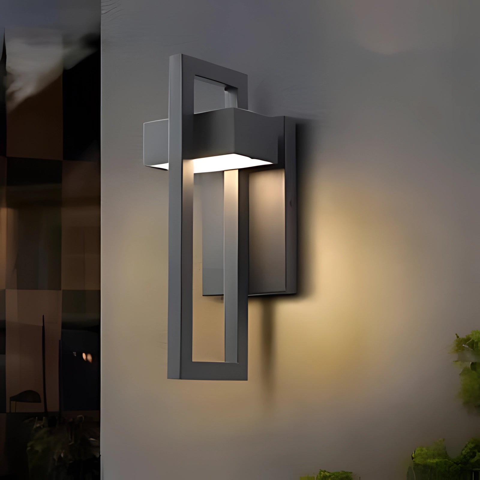 Modern LED outdoor wall light mounted on a contemporary building facade, surrounded by minimalistic urban design elements and nearby greenery.
