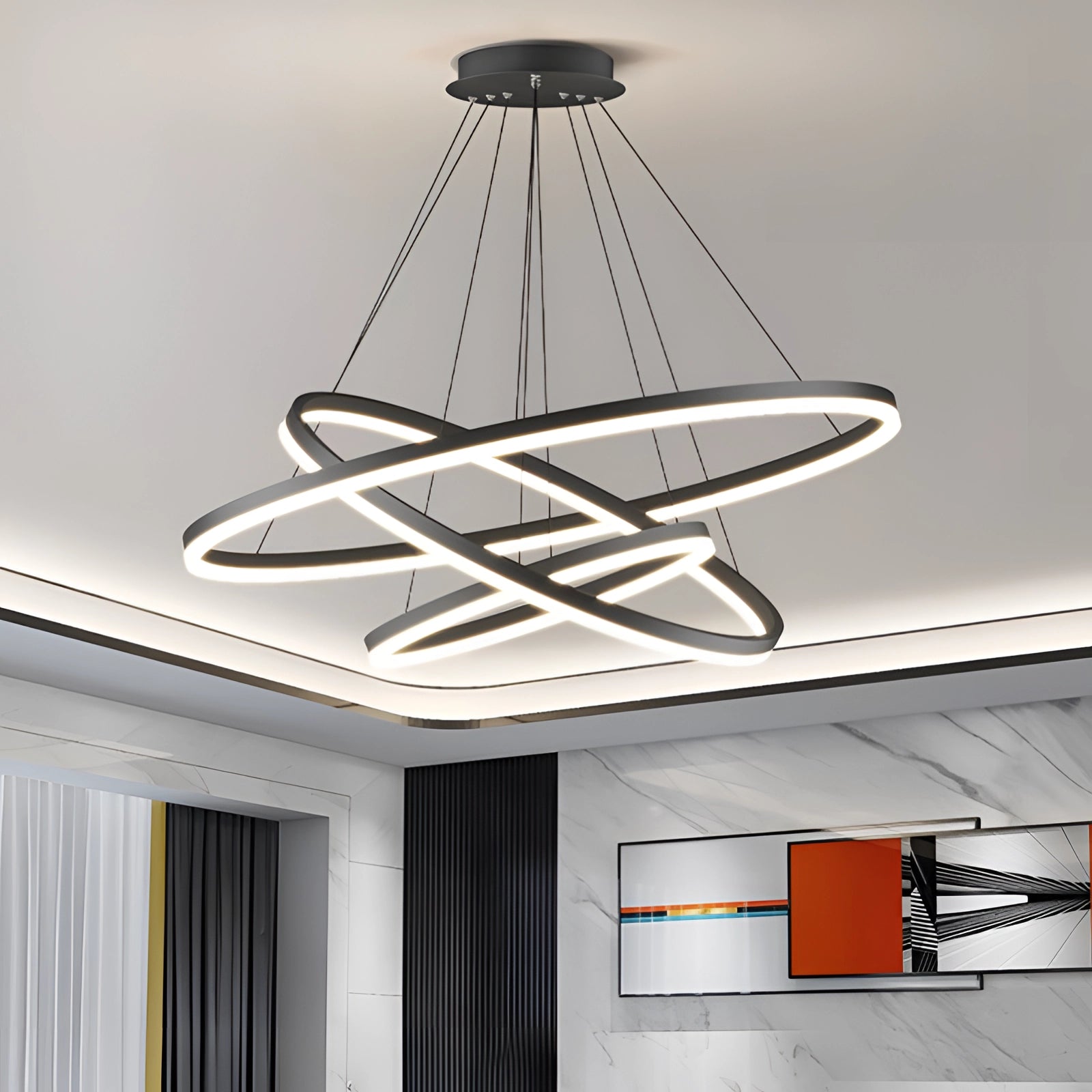 Modern LED pendant light featuring a circular chandelier design with sleek metal accents, hanging from the ceiling, and displaying an orbit-inspired aesthetic.