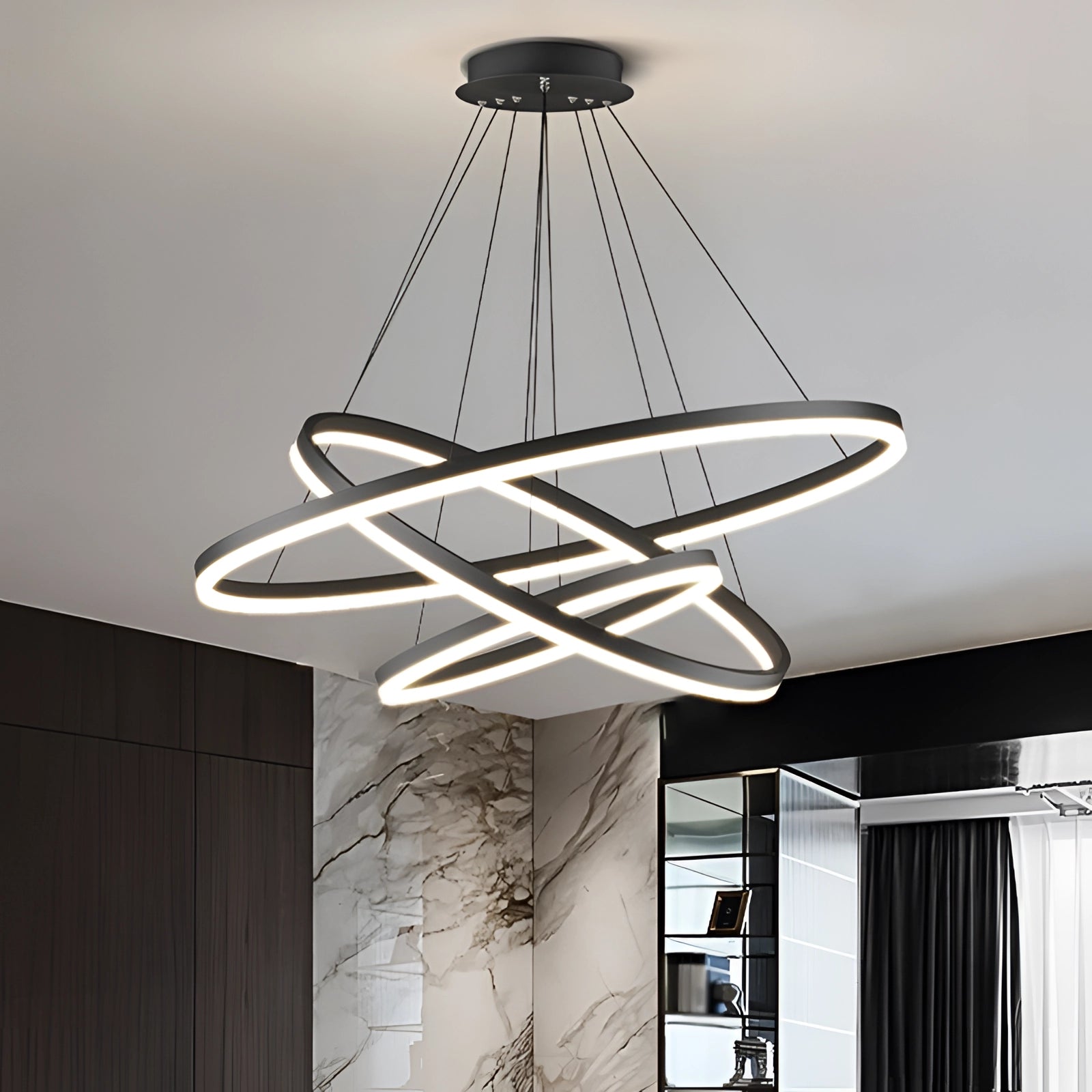 Modern LED pendant light with a circular orbit design, featuring a sleek metal finish and suspended from the ceiling as a contemporary chandelier.