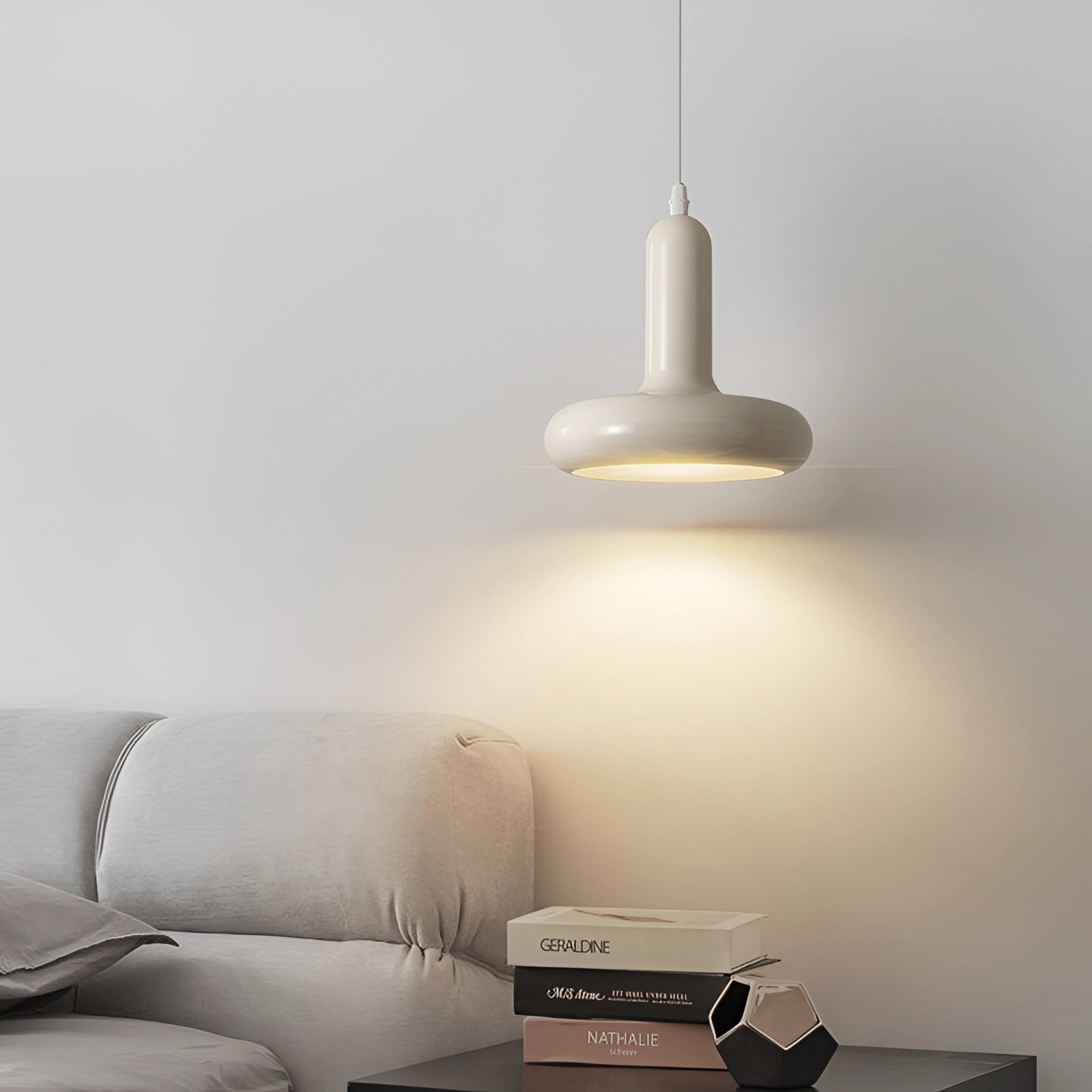 Modern LED pendant light with a sleek, rectangular design and a wooden accent, hanging from the ceiling in a Scandinavian minimalist kitchen and dining room setting. The light features grey tints and shades, complementing the comfortable and stylish decor of the space.