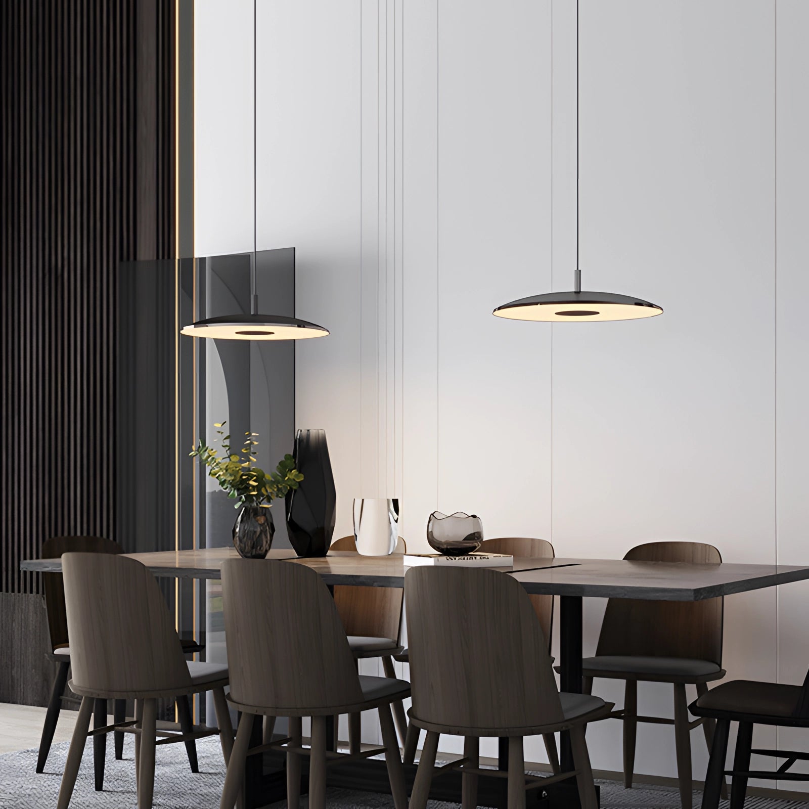 Modern LED pendant lights in stylish silver hanging over a wooden dining table with chairs, indoor plants, and elegant interior design elements.