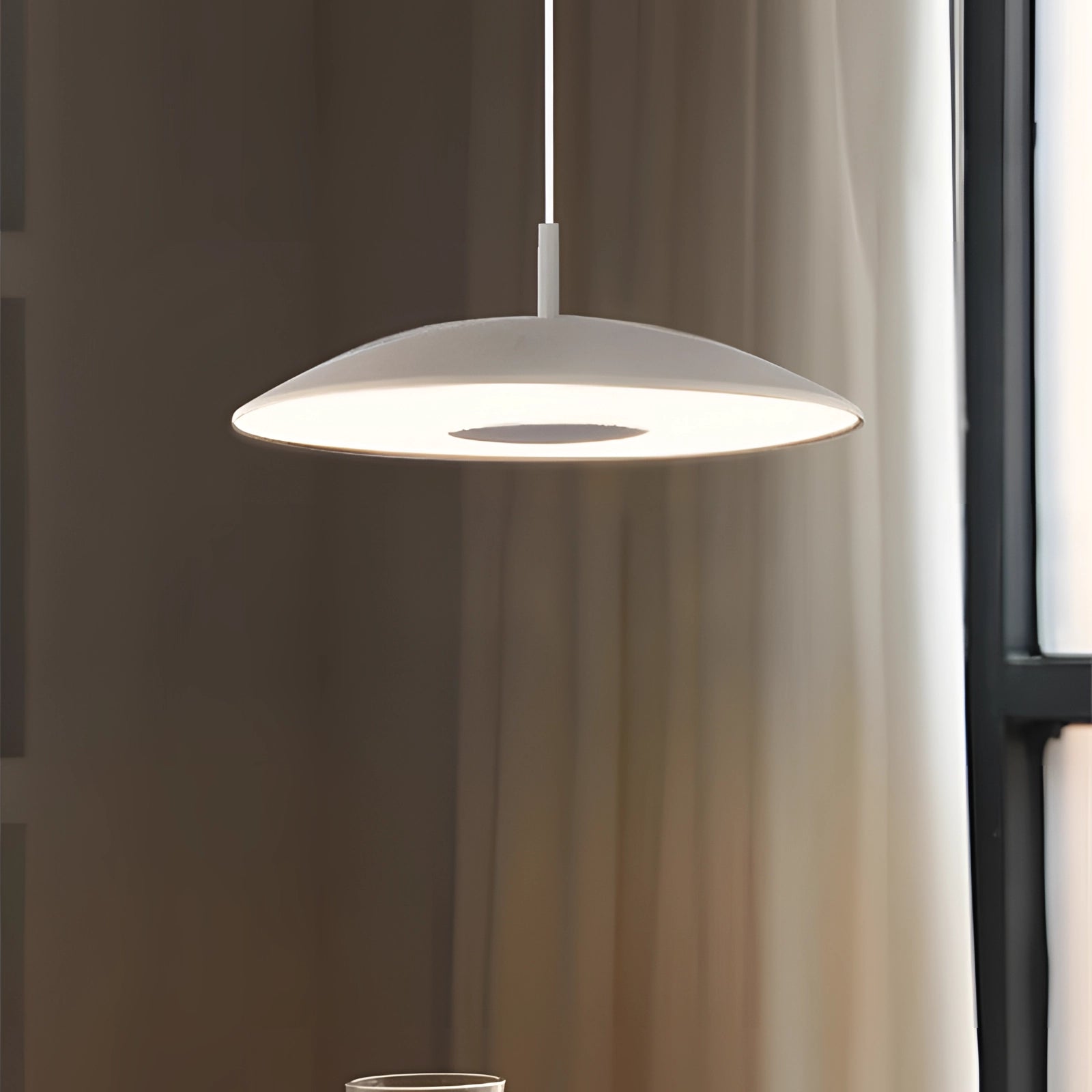 Modern LED pendant lights with stylish silver finish hanging from a wooden ceiling, illuminating a dining room.
