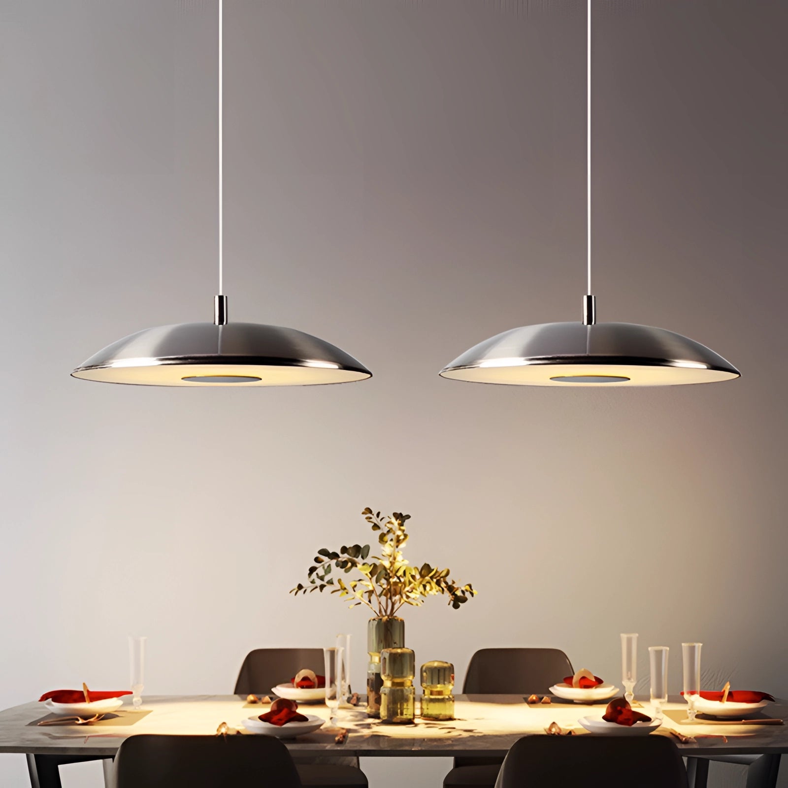 Modern LED pendant lights in stylish silver hanging above a dining table, enhancing the room's interior design with elegant illumination.