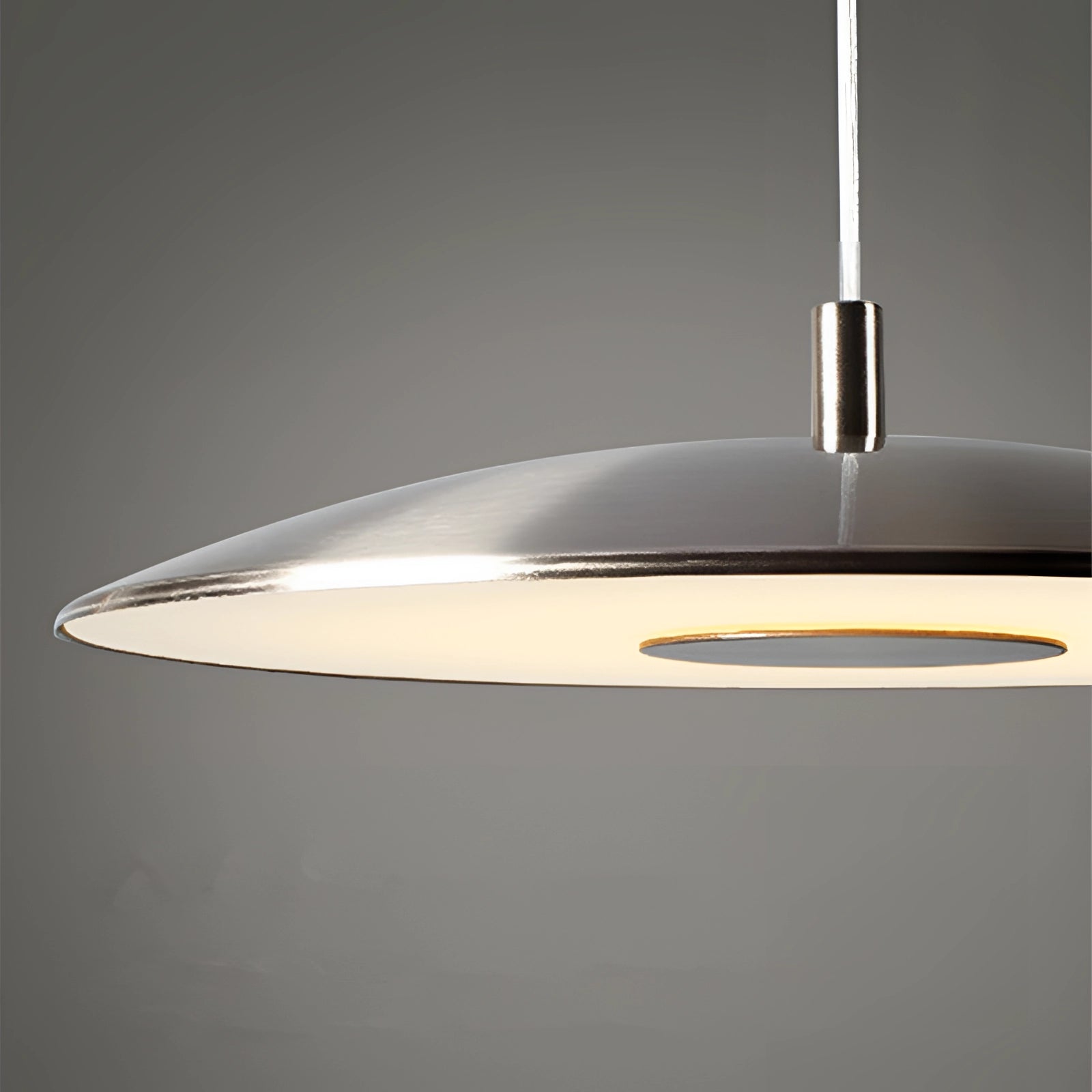 Modern LED pendant lights in stylish silver, hanging in a dining room, illuminating the space with a contemporary design.