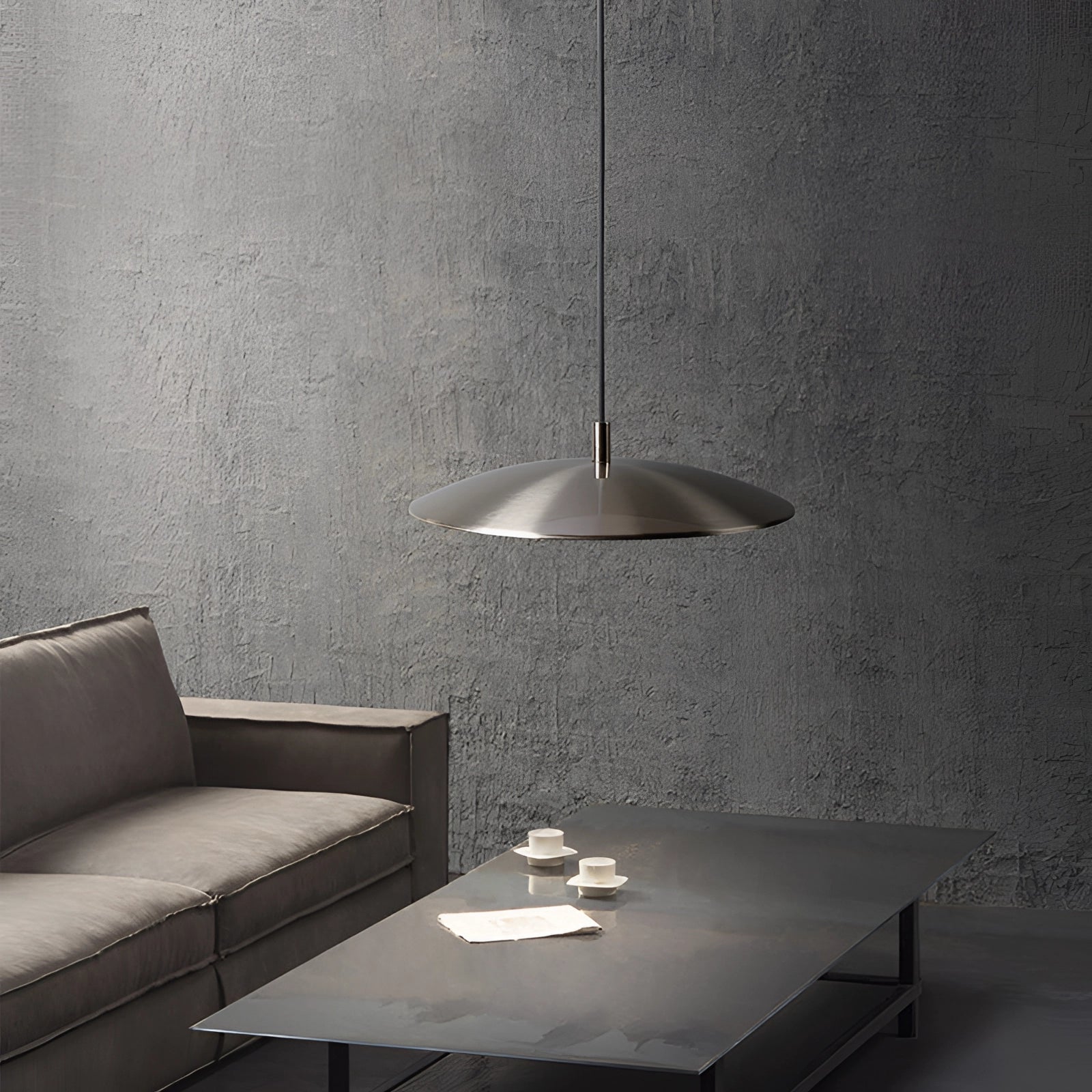 Modern LED pendant lights in stylish silver hanging above a wooden dining table, with contemporary interior design elements visible in the background.