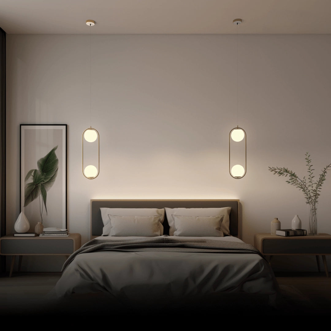 Modern LED round bedside lamp in a minimalist gold frame, emitting cold white light; positioned on a wooden surface with a potted plant and a picture frame nearby, creating a cozy and stylish interior design ambiance.