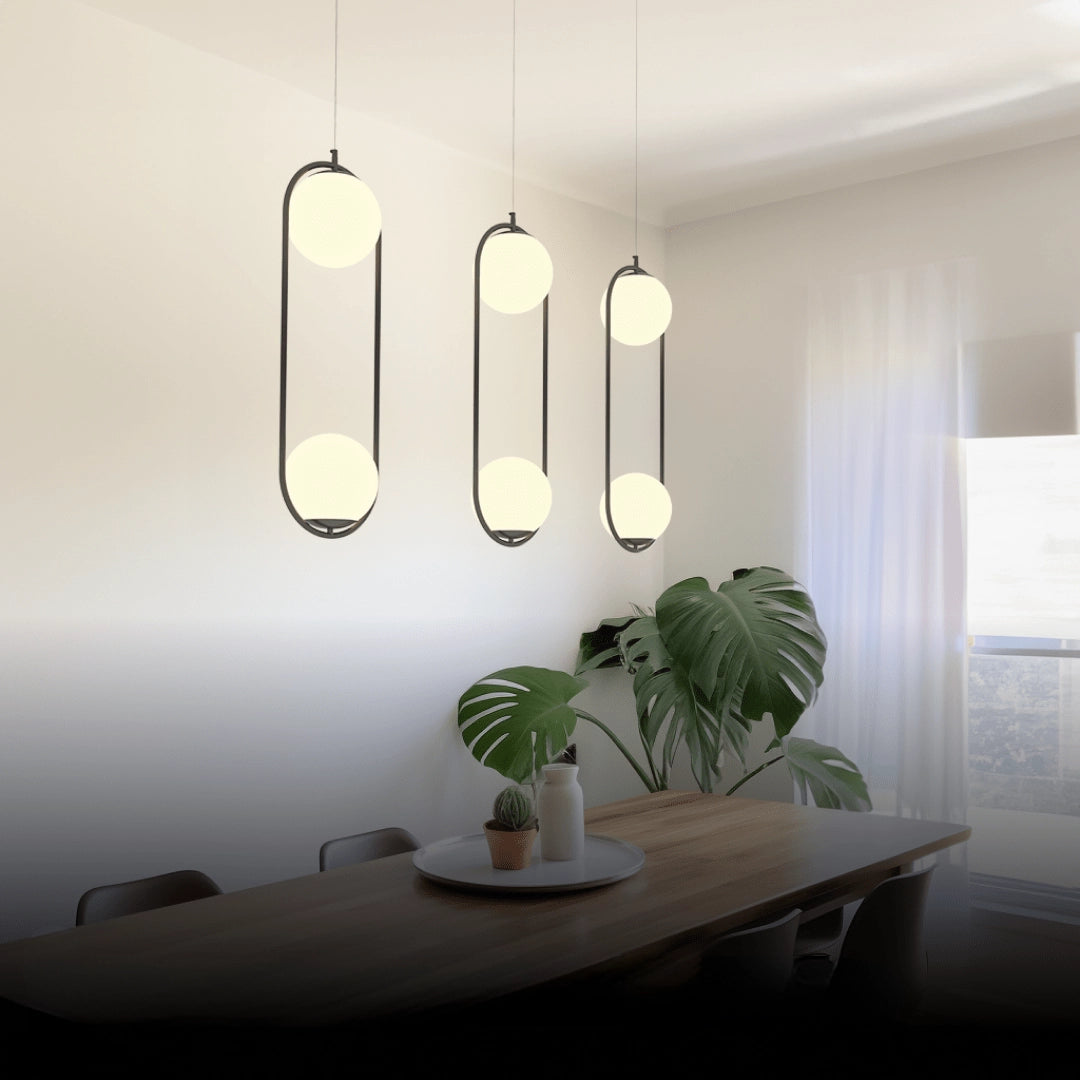 Modern LED round bedside lamp with a minimalist black base and sleek cold white light, placed on a wooden table alongside a small plant, enhancing the interior design with its artistic and contemporary aesthetic.