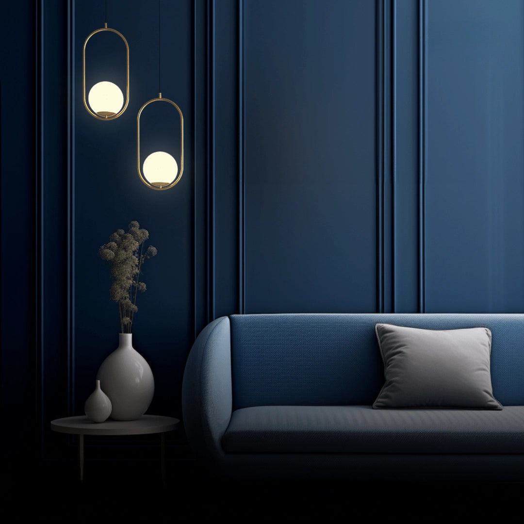 Modern LED round bedside lamp with a minimalist design in a gold finish, emitting a cold white light. The lamp is placed in a stylish interior setting with grey tones, featuring wooden furniture and a comfortable couch, enhancing the decor and ambiance of the room.