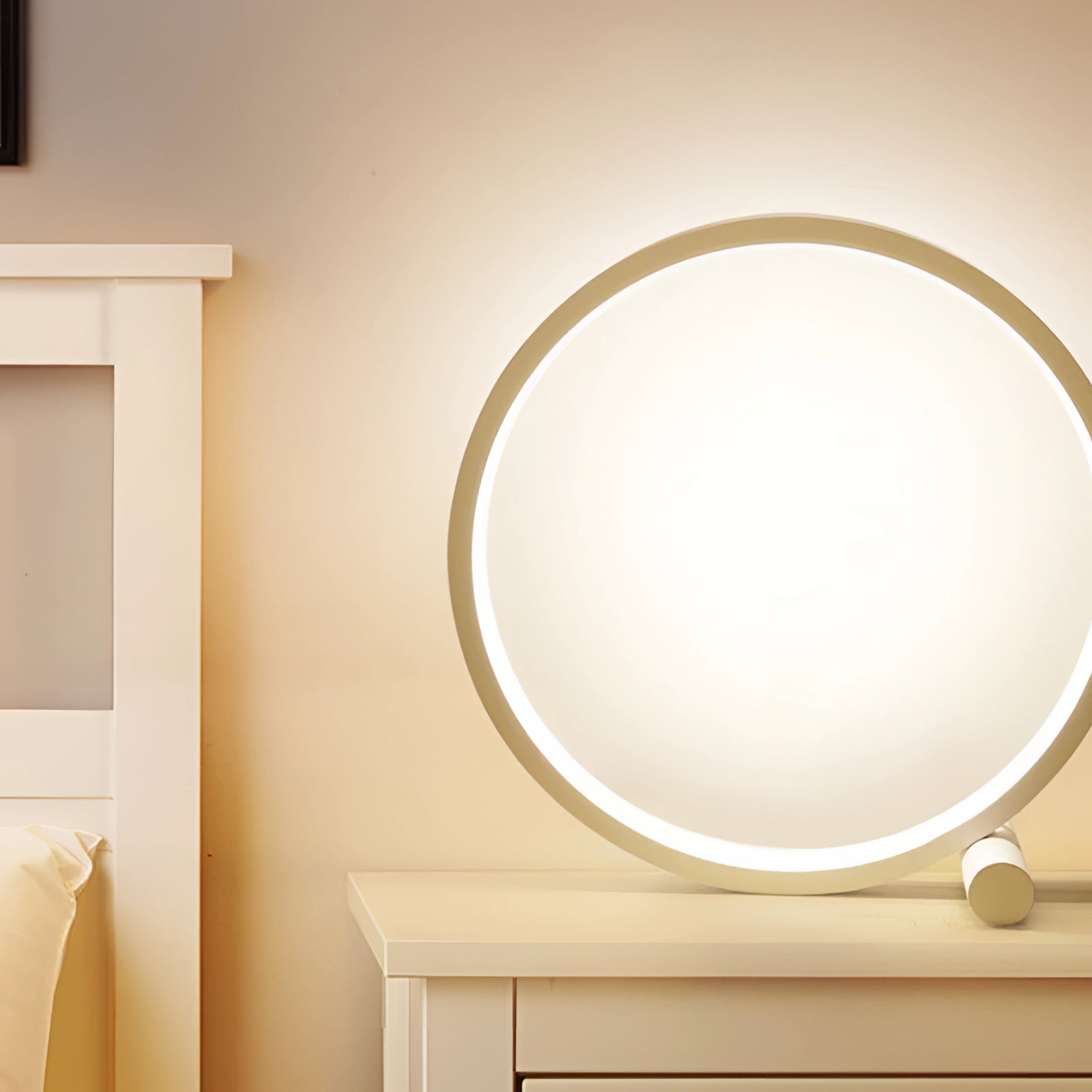 Modern LED table lamp with a circular design, emitting warm light, placed on a wooden surface in a minimalist interior setting.