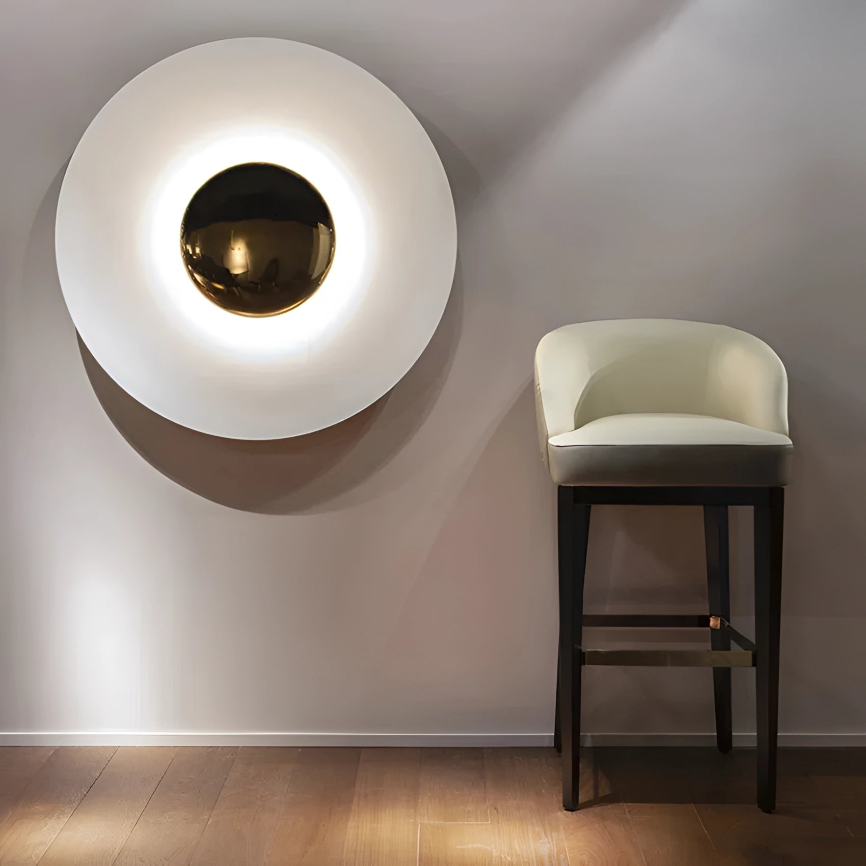 Modern LED wall lamp with a minimalistic brass design mounted on a wooden wall, featuring clean lines and a warm glow, complementing the sophisticated interior design.