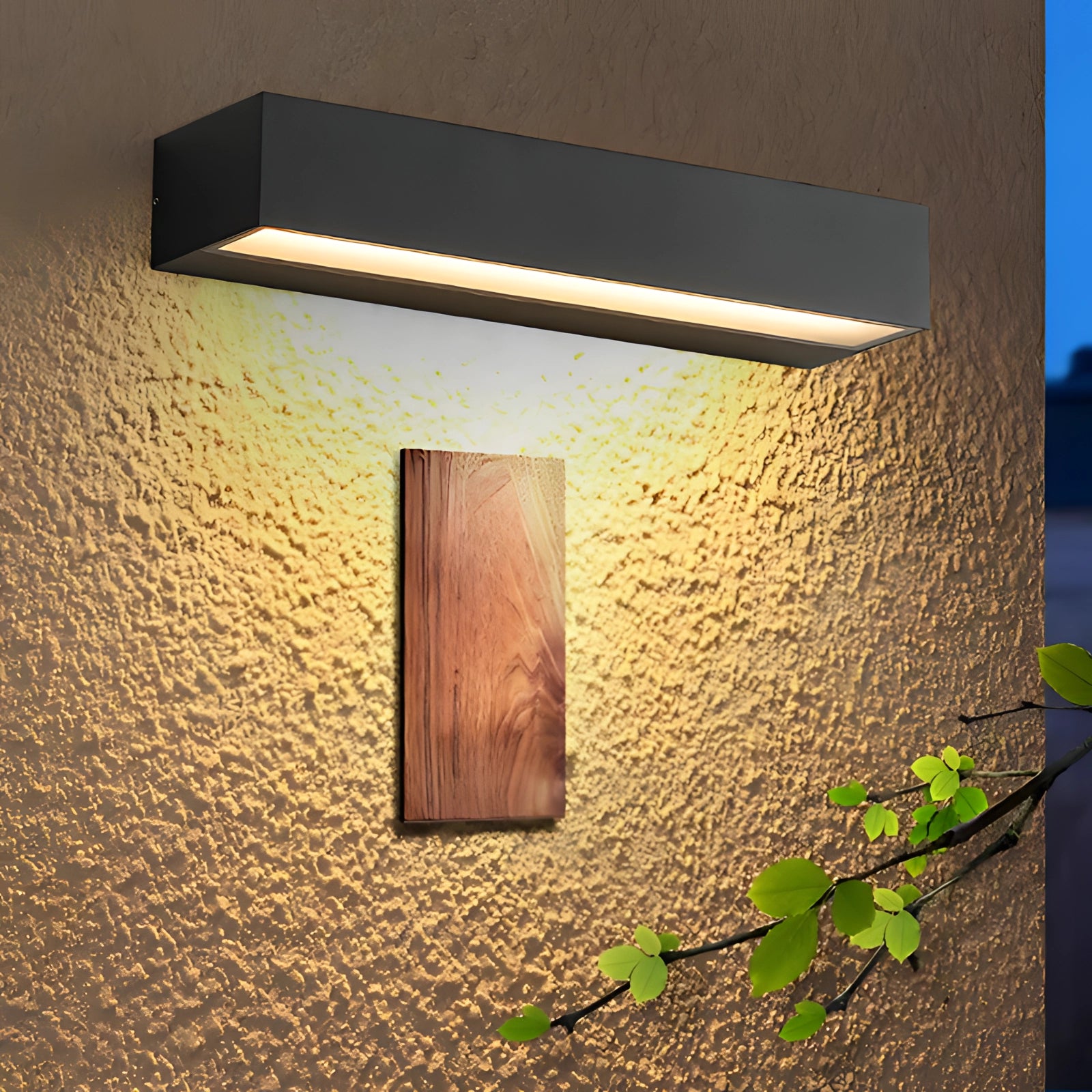 A sleek black modern LED wall light sconce mounted on a brick wall, with a minimalistic rectangular design featuring a wooden accent, illuminated by sunlight.