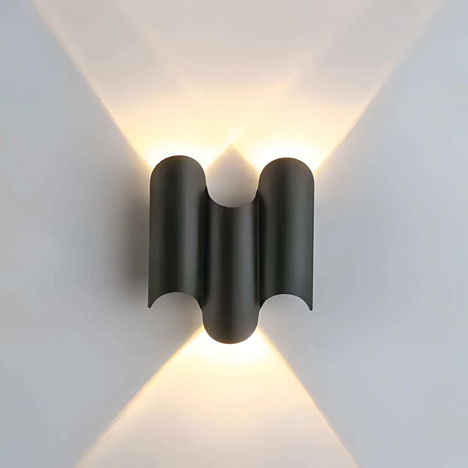 Black geometric LED wall sconce with indirect lighting, featuring a modern design and circular elements, mounted on a wall.