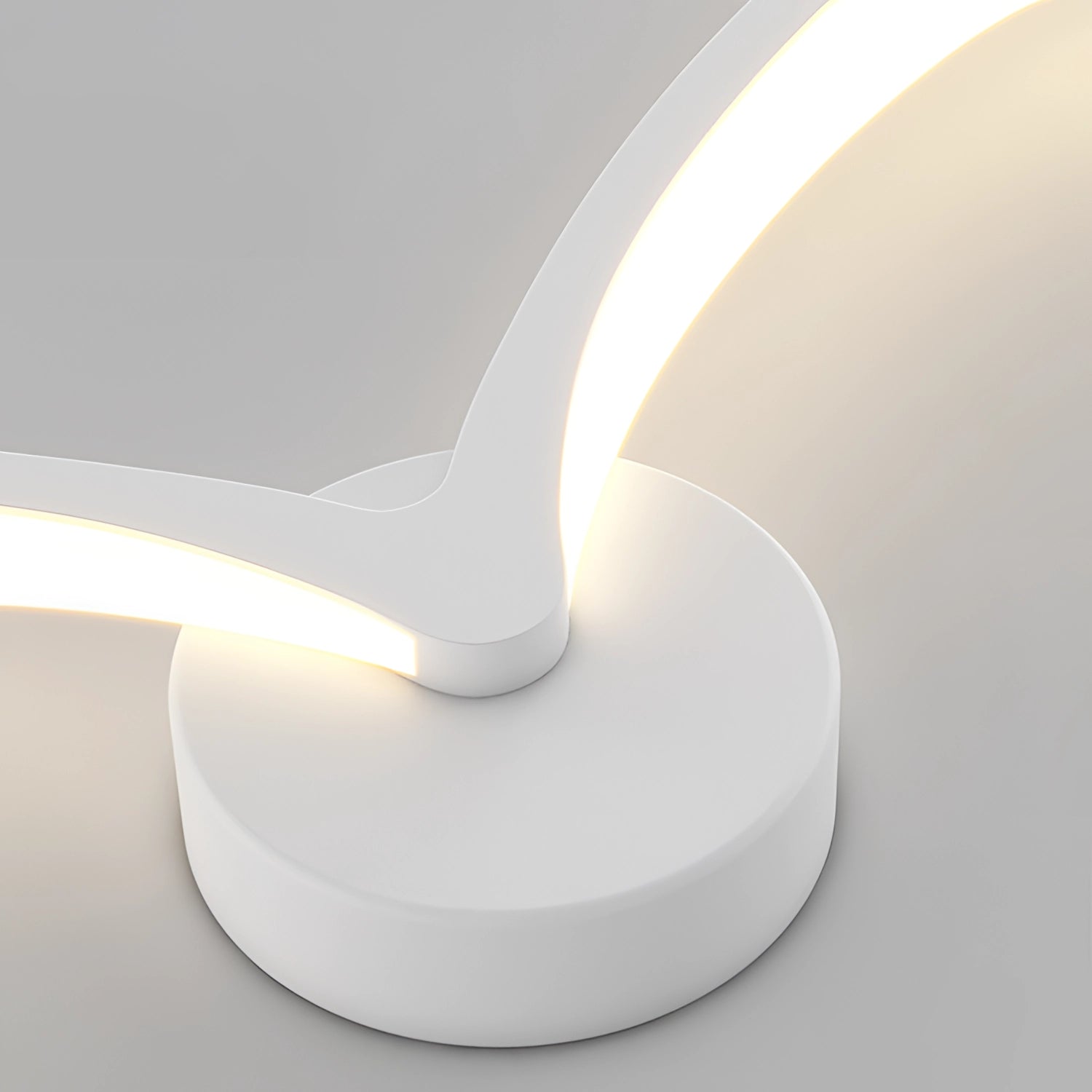 A modern LED wall sconce with a sleek curved design, perfect for minimalist bedroom lighting. The fixture showcases a circular shape with a contemporary aesthetic, featuring a smooth, composite material that complements modern interiors.