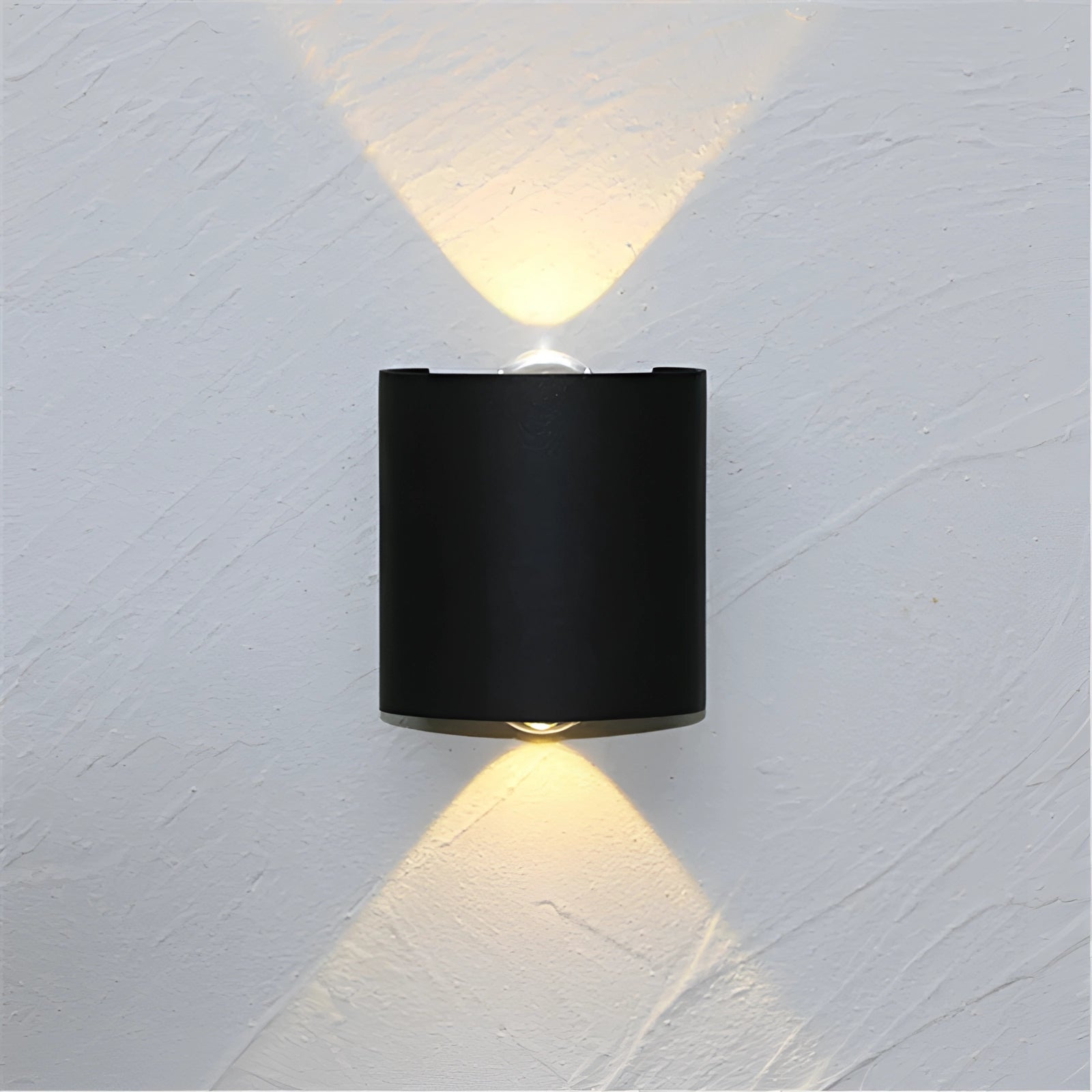 
A black modern LED wall sconce with a geometric cylinder design, featuring dual beam light.