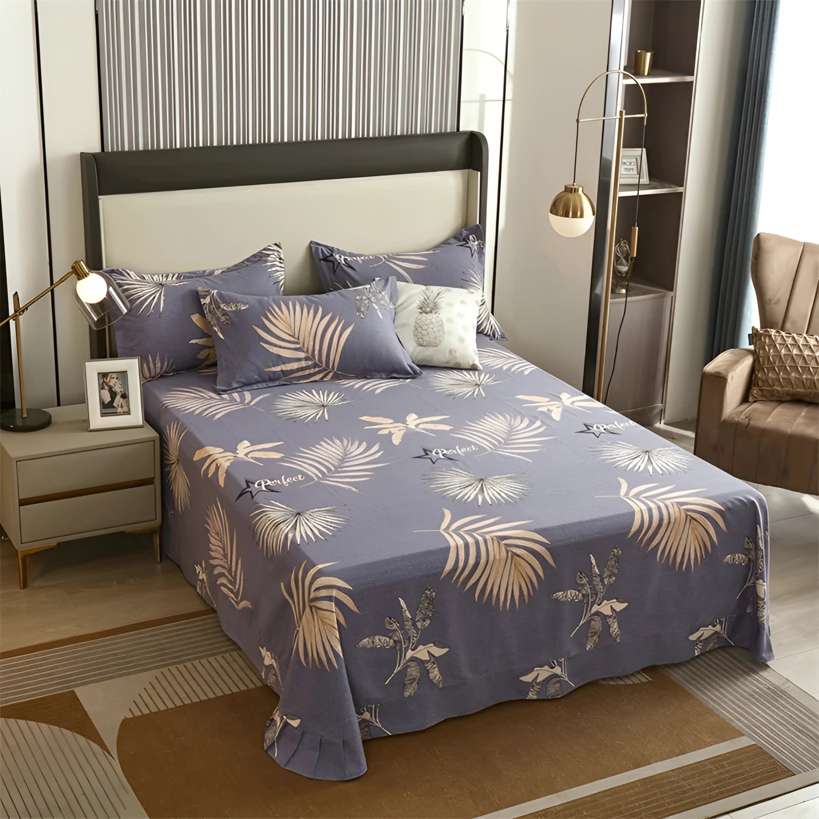 Modern luxury bedding set featuring a geometric bedsheet and striped duvet cover spread over a large bed with a wooden bed frame. The room is elegantly decorated with comfortable pillows and a bedside lamp, showcasing a sophisticated interior design.