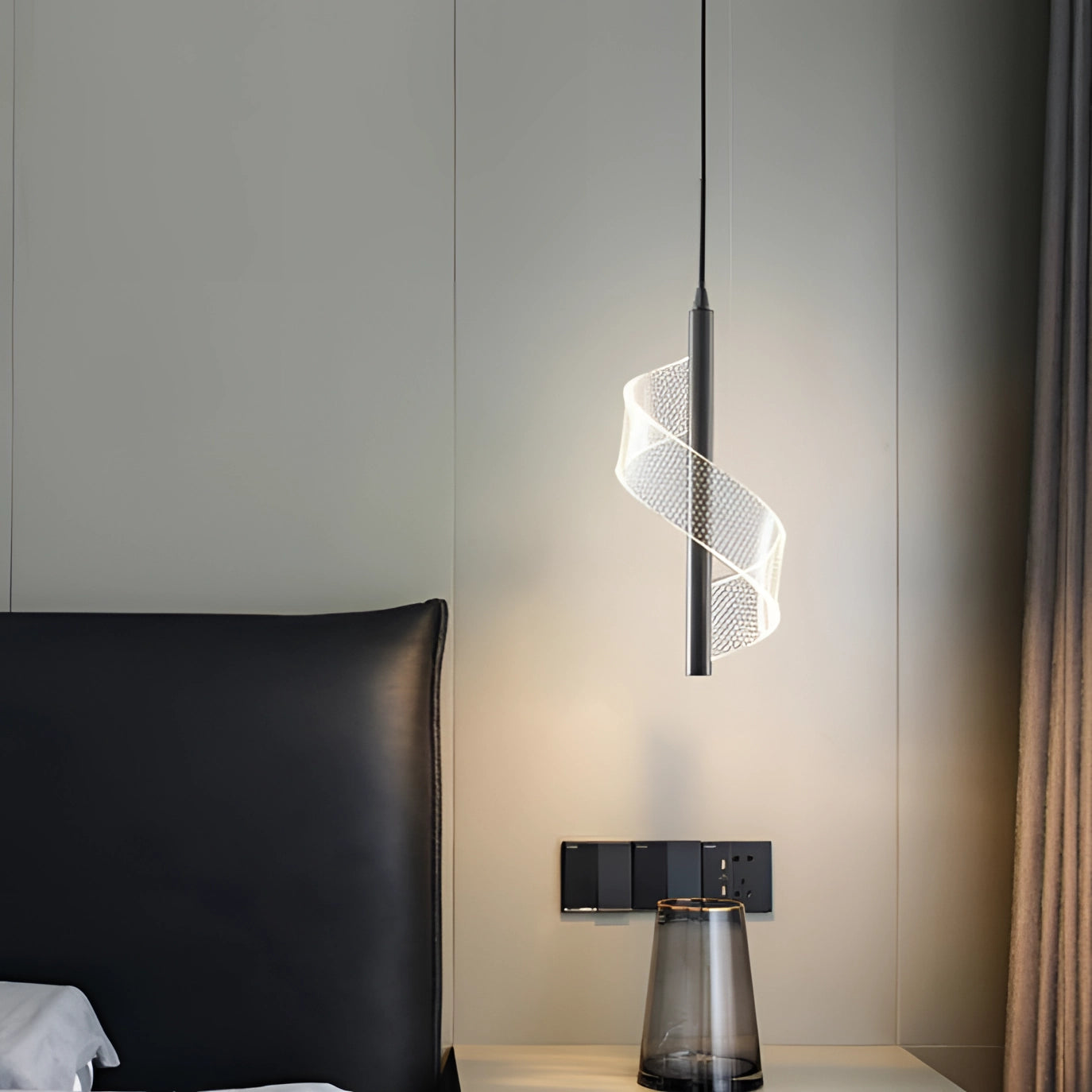 Modern luxury pendant light with a geometric design and gold accents, hanging in an elegant interior space featuring wooden flooring and minimalist decor elements.
