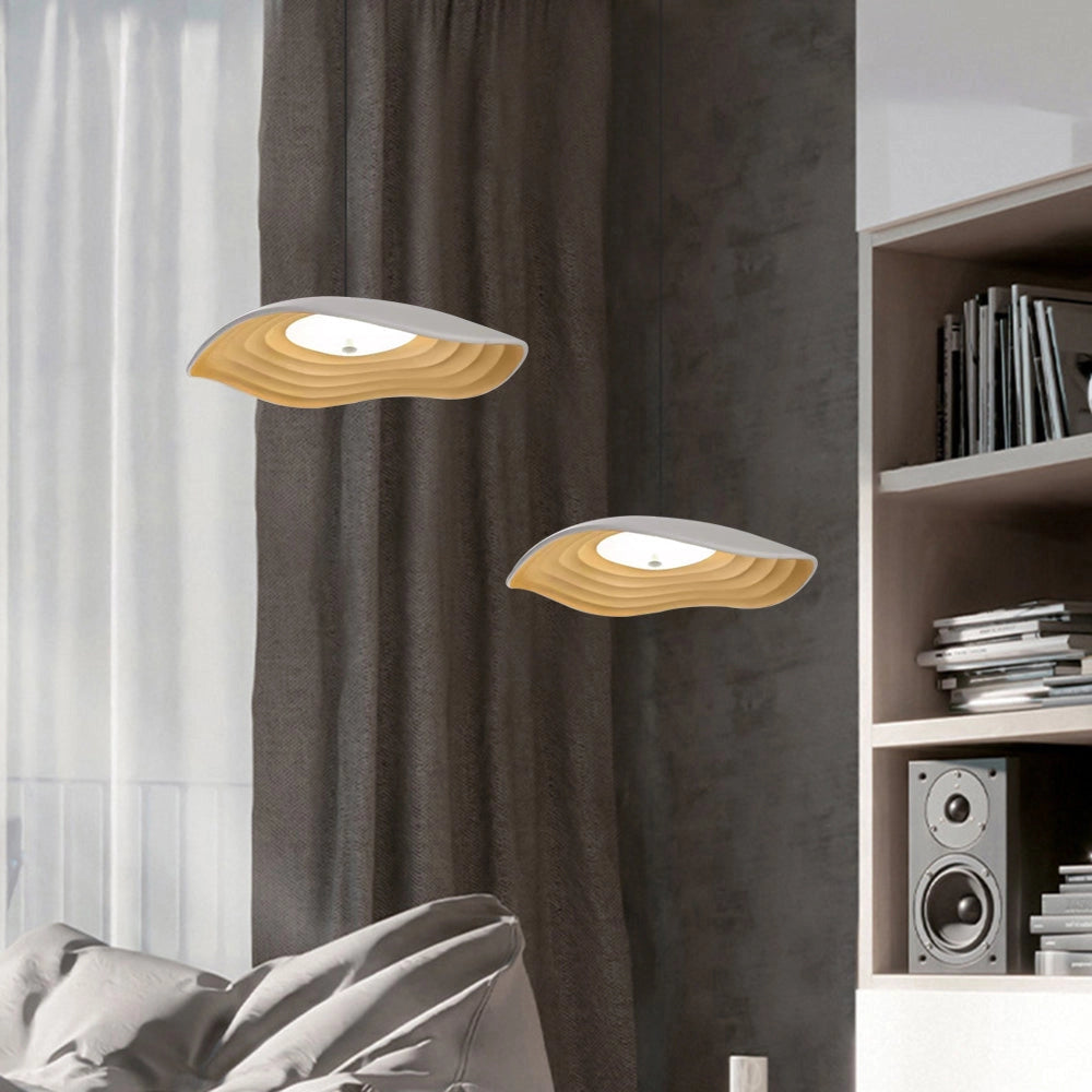 Modern luxury pendant light with LED illumination and wooden accents elegantly hanging in a stylish living room featuring a grey color scheme, wooden bookcase shelves, and curtains.
