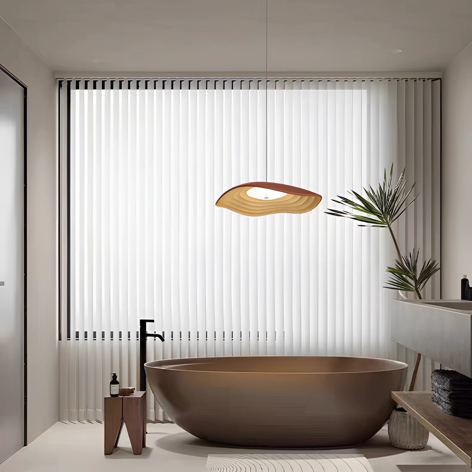 Modern luxury pendant light with a single head, featuring an elegant orange design and wooden accents, installed in a tastefully designed interior space.