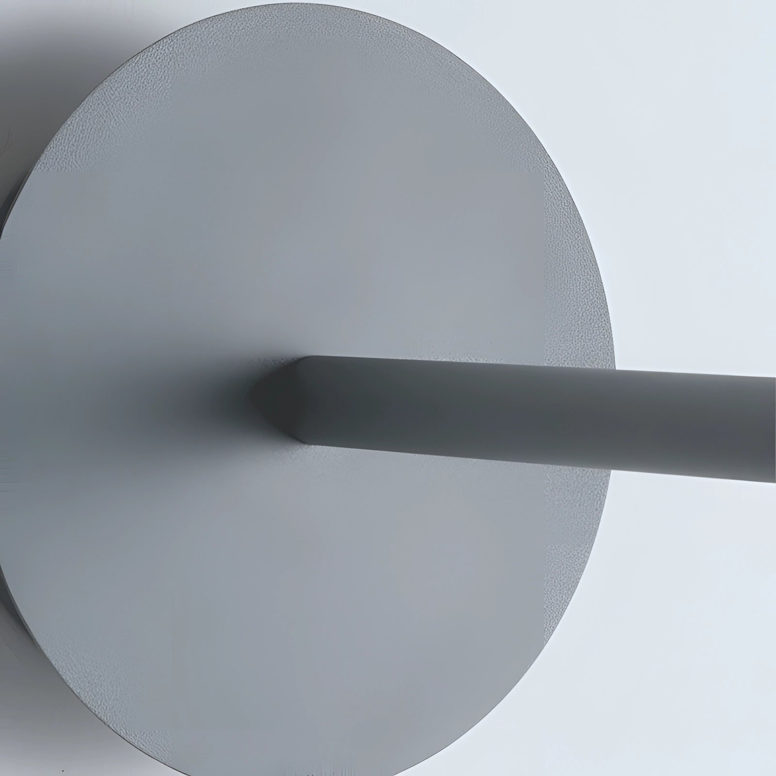 Modern matte black minimalist wall sconce mounted on a wall, designed for bedroom and hallway lighting, featuring a sleek circular metal frame.