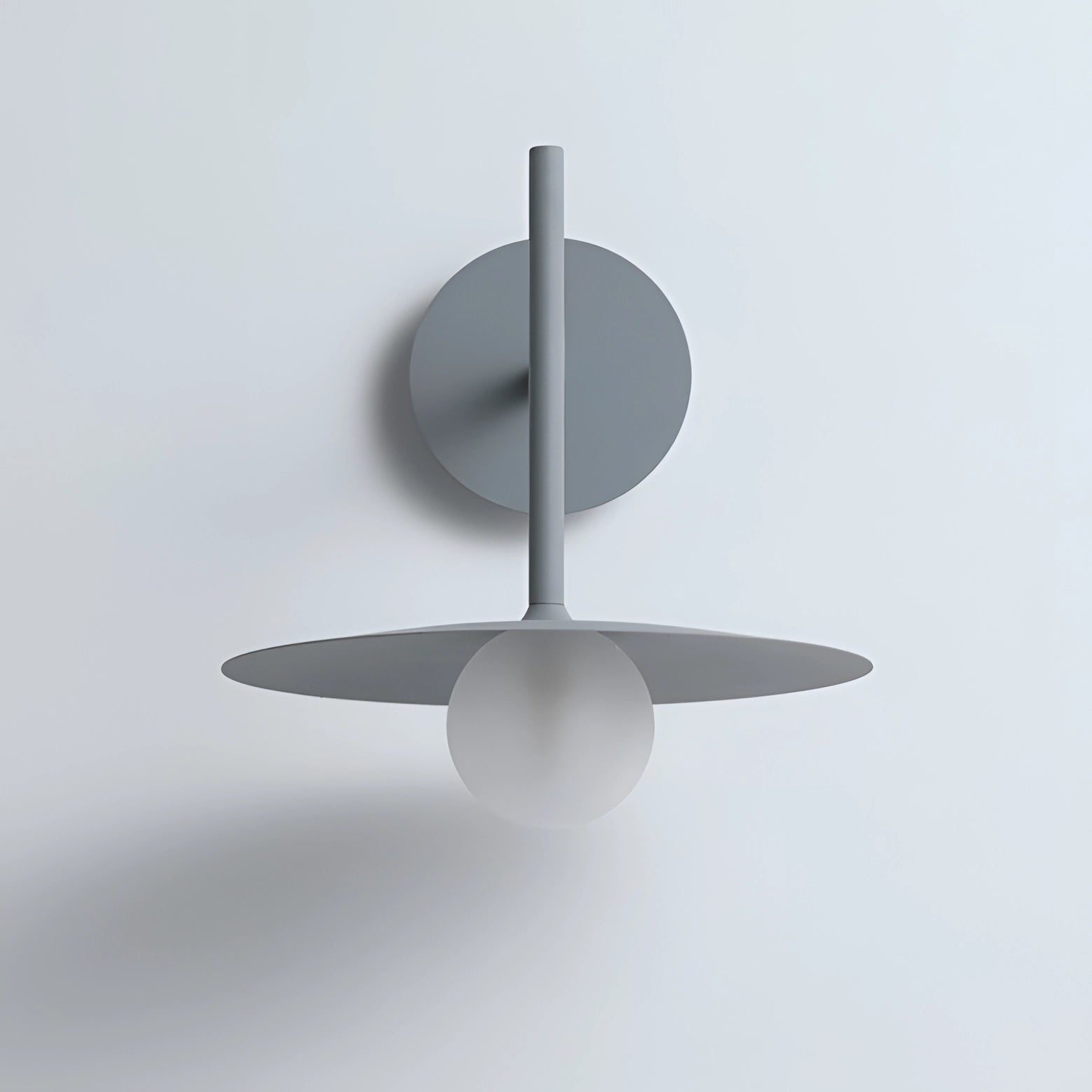 Modern matte black minimalist wall sconce featuring a circular design, crafted from metal, ideal for bedroom and hallway lighting, mounted on a wall.