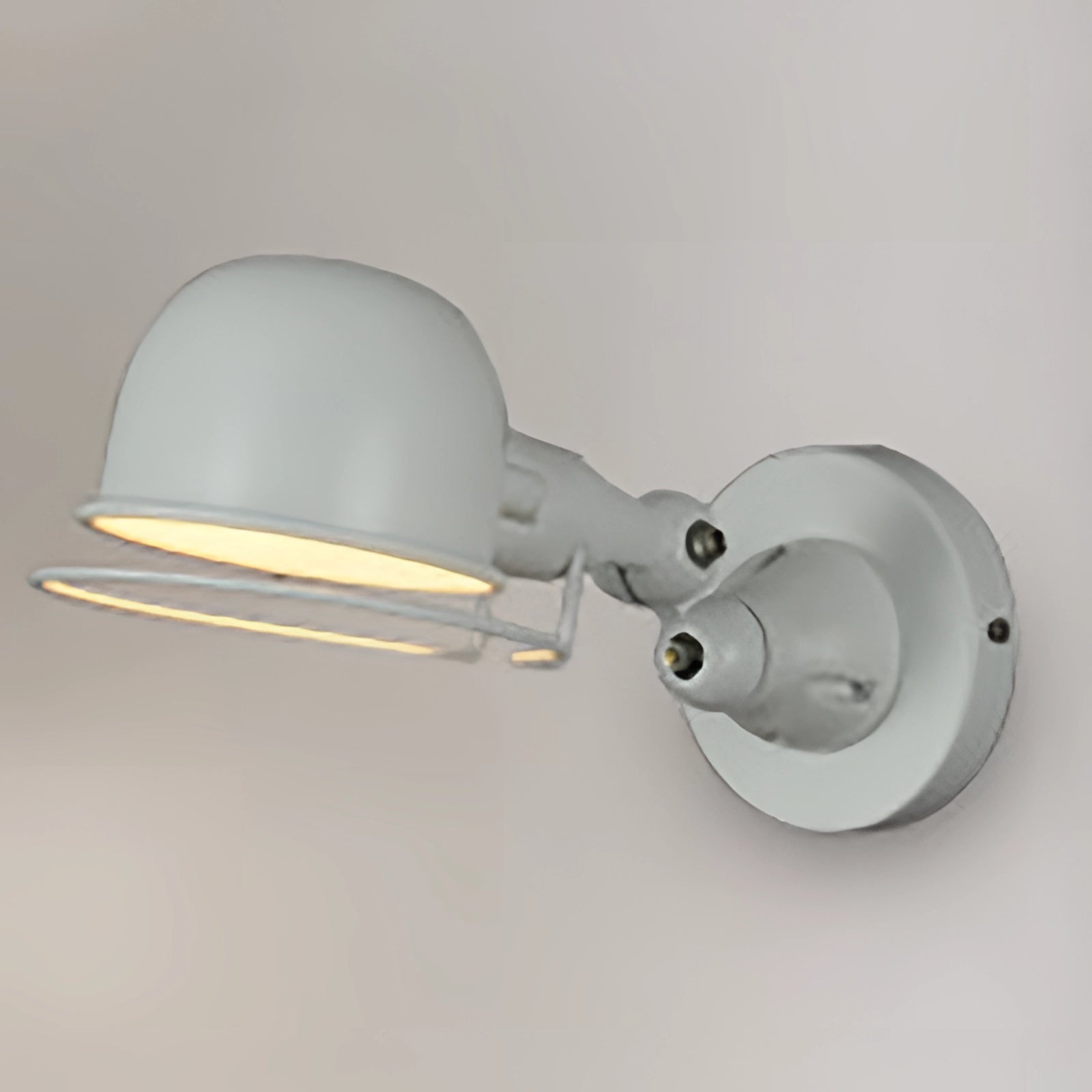 Modern matte black swing arm wall lamp with adjustable metal sconce, featuring a white finish and a short arm design.