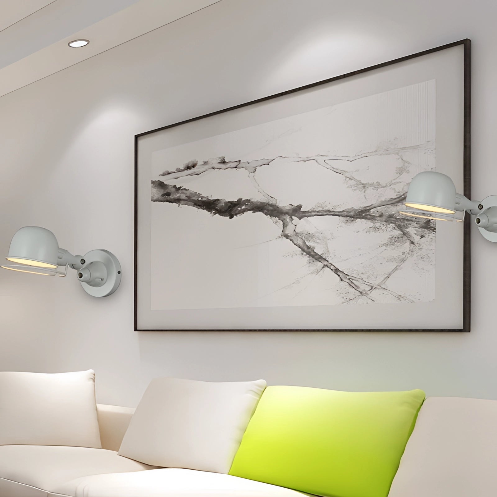 Modern matte black swing arm wall lamp mounted on a white wall above a couch, featuring an adjustable arm for flexible lighting, with contemporary interior design elements including wooden furniture and framed art.