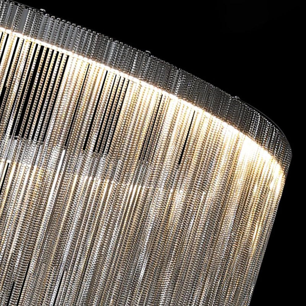 Modern metallic fringe chandelier with a luxurious contemporary design, featuring a rectangular shape and intricate grille pattern, casting electric blue light and tints and shades against a metal finish.