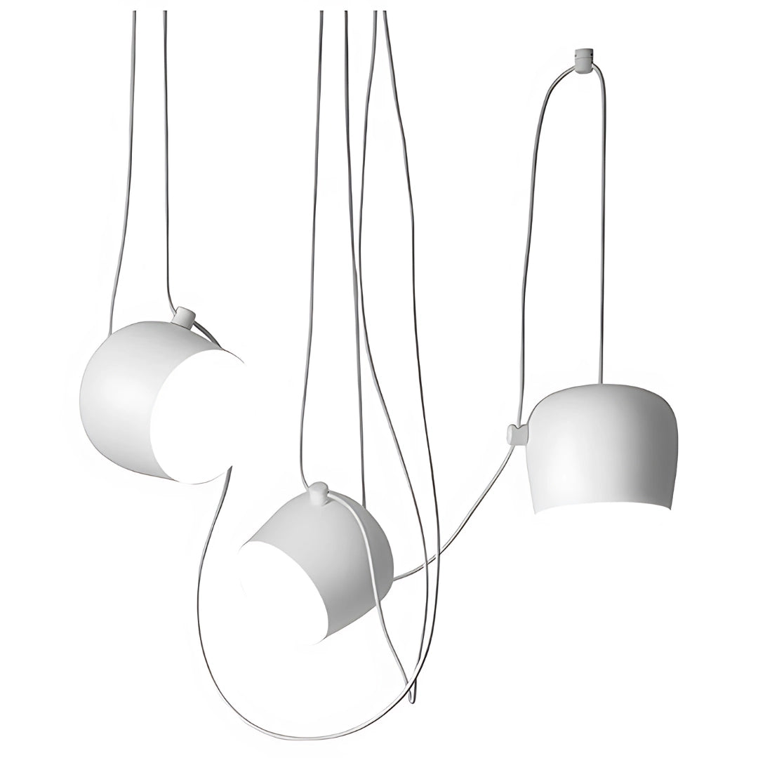 Modern minimalist bookshelf in white with five shelves, featuring decorative items such as a potted plant, a lamp, and audio equipment. The surrounding area includes art pieces, ceiling fixtures, and other decorative elements.