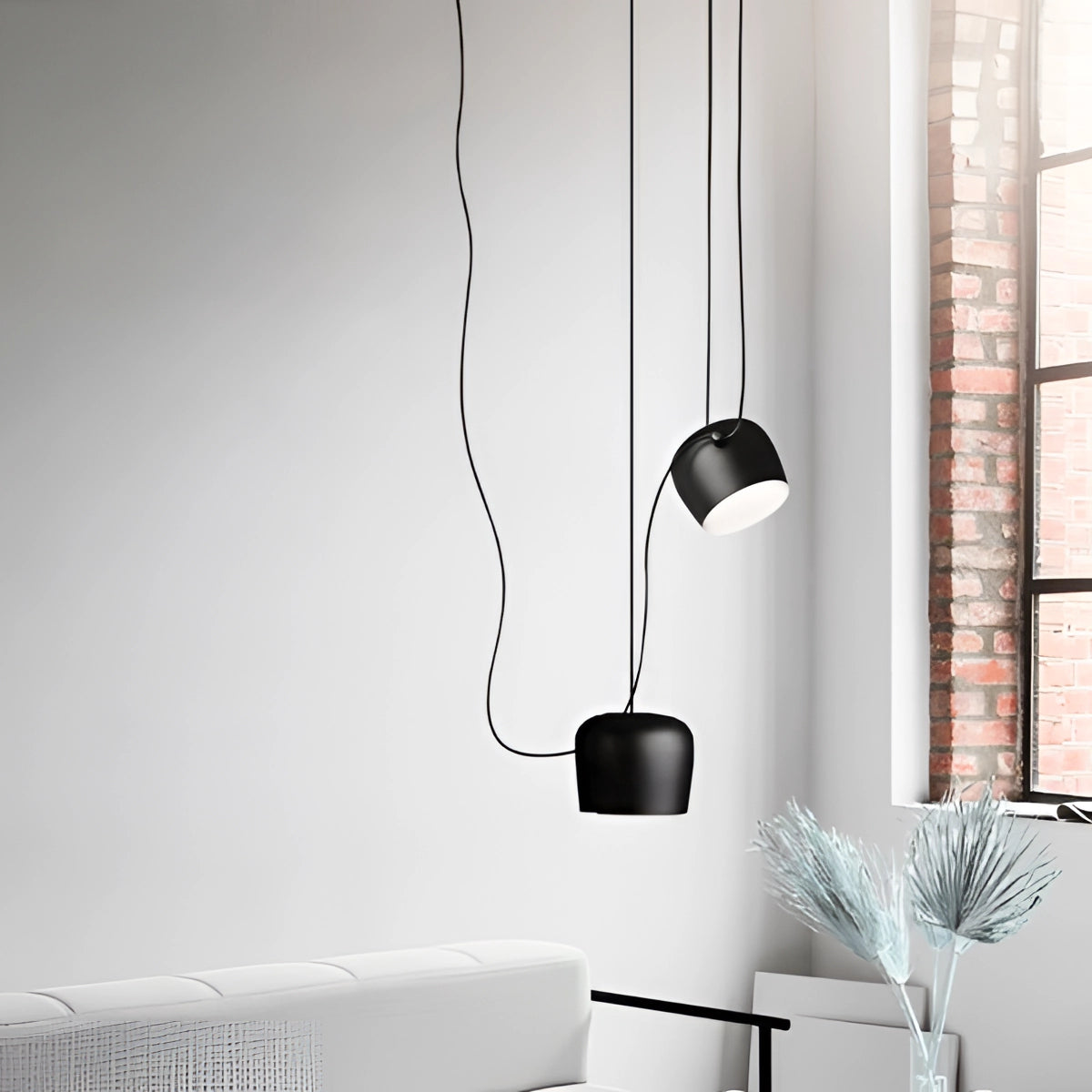 Modern minimalist bookshelf featuring a stylish blue and white color scheme, situated in a contemporary interior design setting with a grey couch and black-and-white elements.