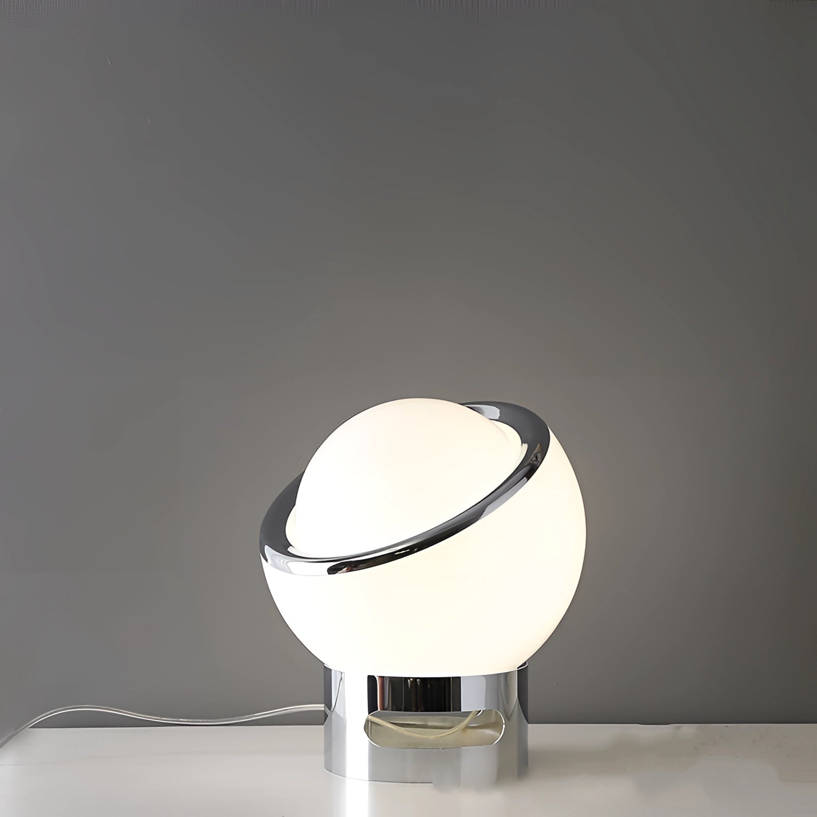 Modern Minimalist Circular LED Bedside Lamp with sleek metallic base in white, placed on a table.