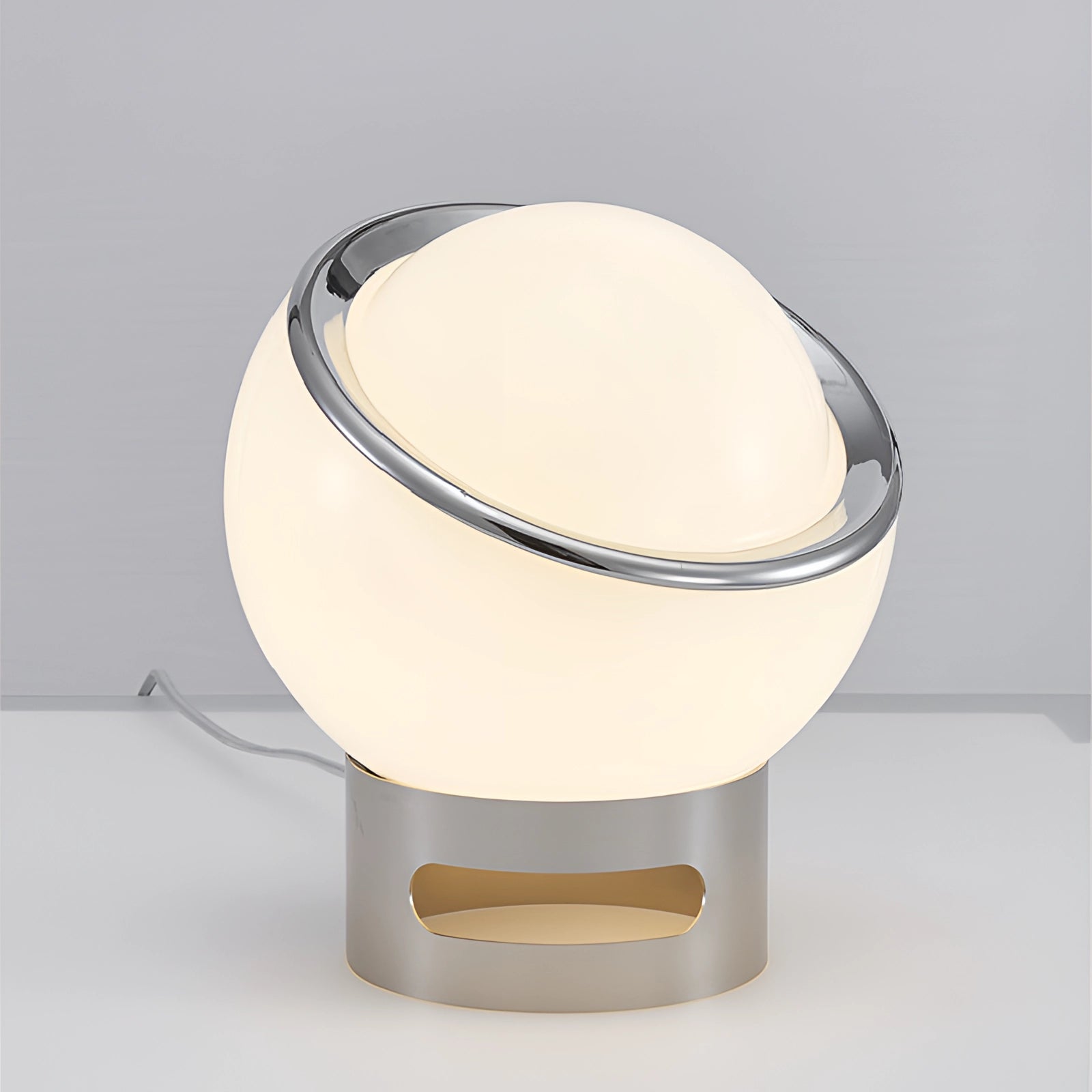 Modern Minimalist Circular LED Bedside Lamp with a Sleek Metallic Base, featuring a simple and elegant circular design.
