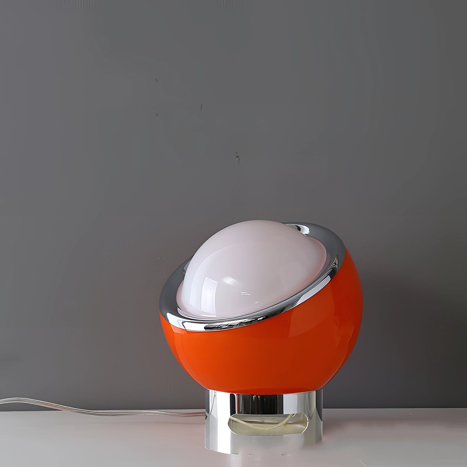 Modern Minimalist Circular LED Bedside Lamp with Sleek Metallic Base in Red, placed on a table.
