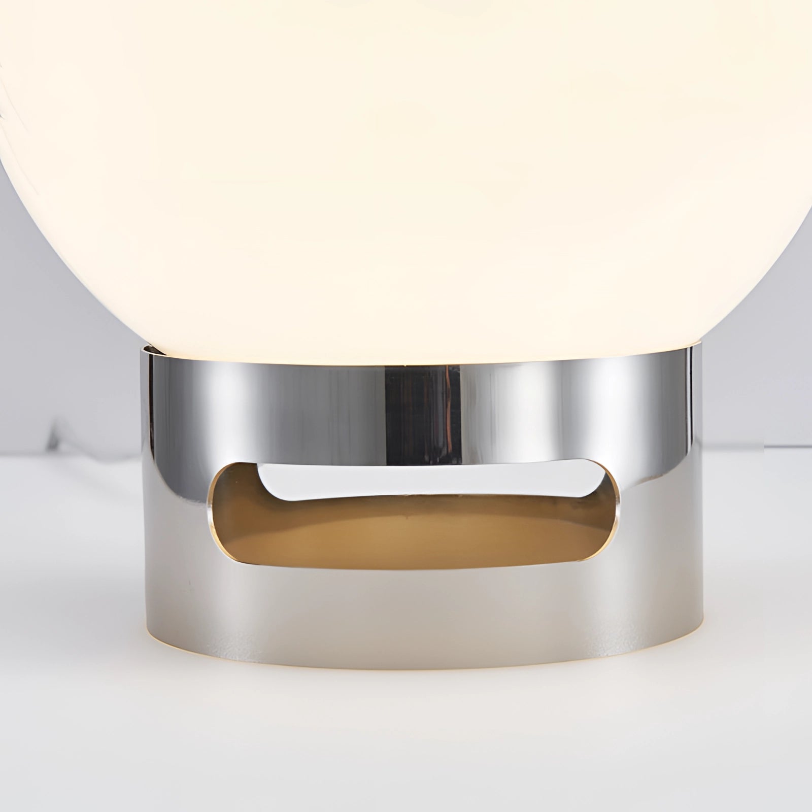Modern Minimalist Circular LED Bedside Lamp with Sleek Metallic Base on a table.