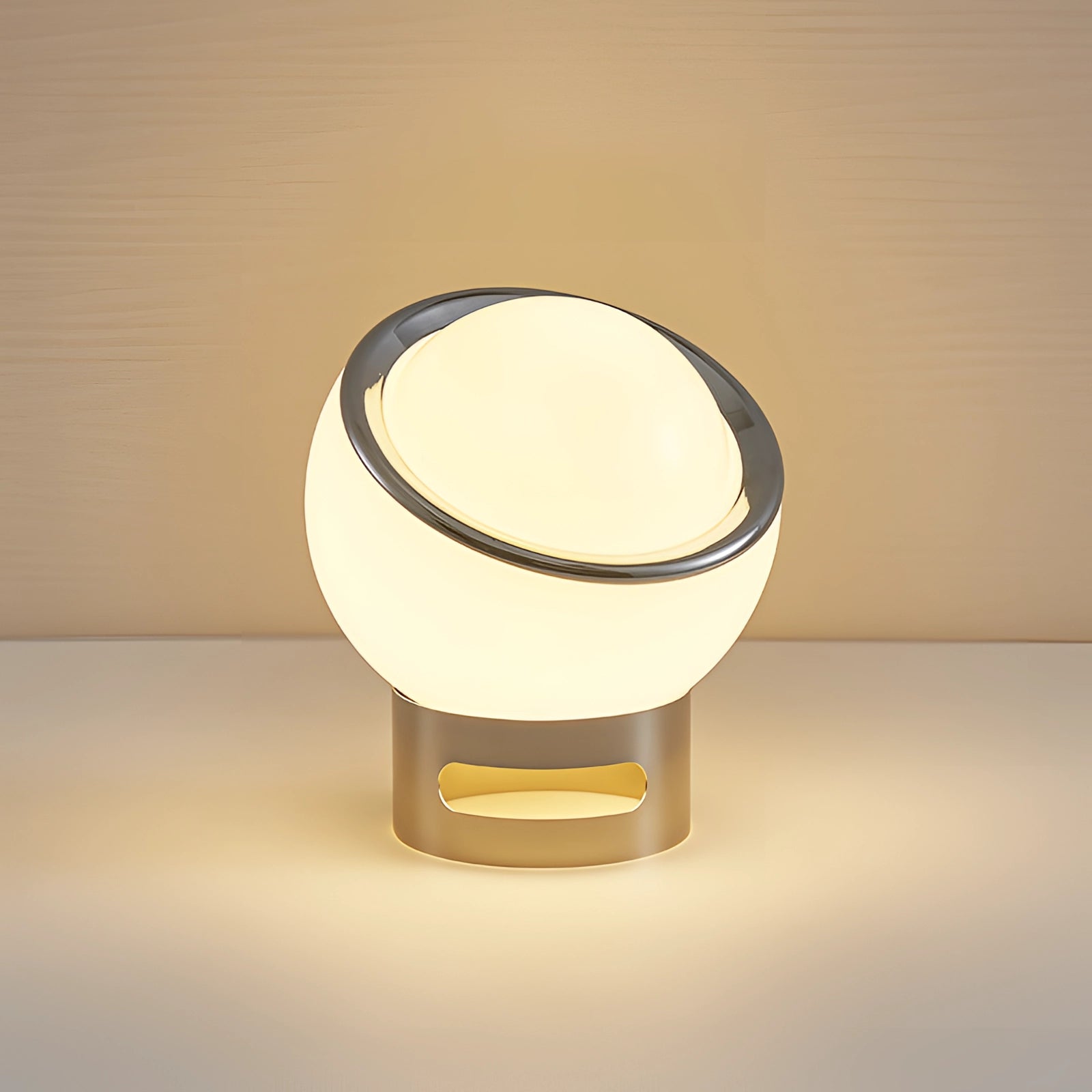 Modern minimalist circular LED bedside lamp with sleek metallic base, featuring a ring-shaped design and contemporary aesthetic.