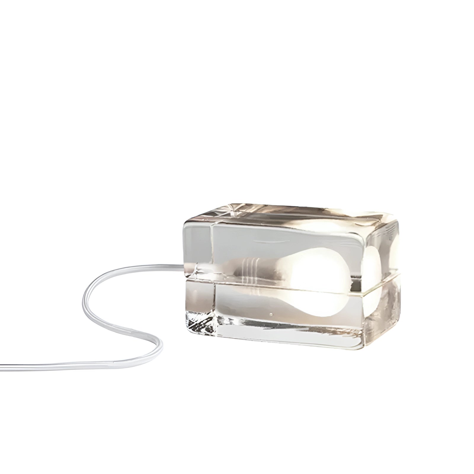 Clear glass cube table lamp with a minimalist design, featuring a white base.
