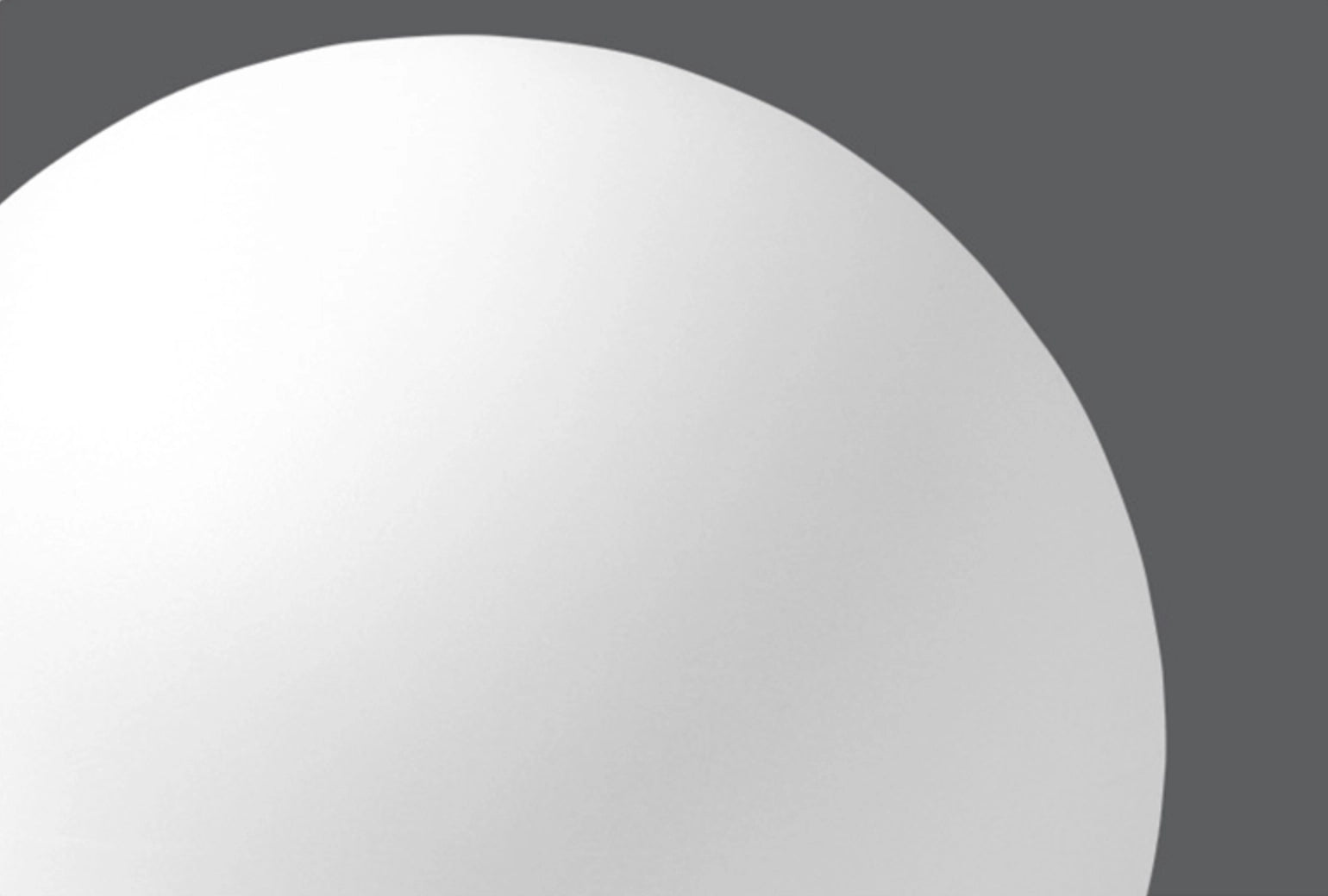 Modern Minimalist LED Globe Lamp glowing in the dark, featuring a rechargeable cordless design with a grey finish and symmetrical circular shape.