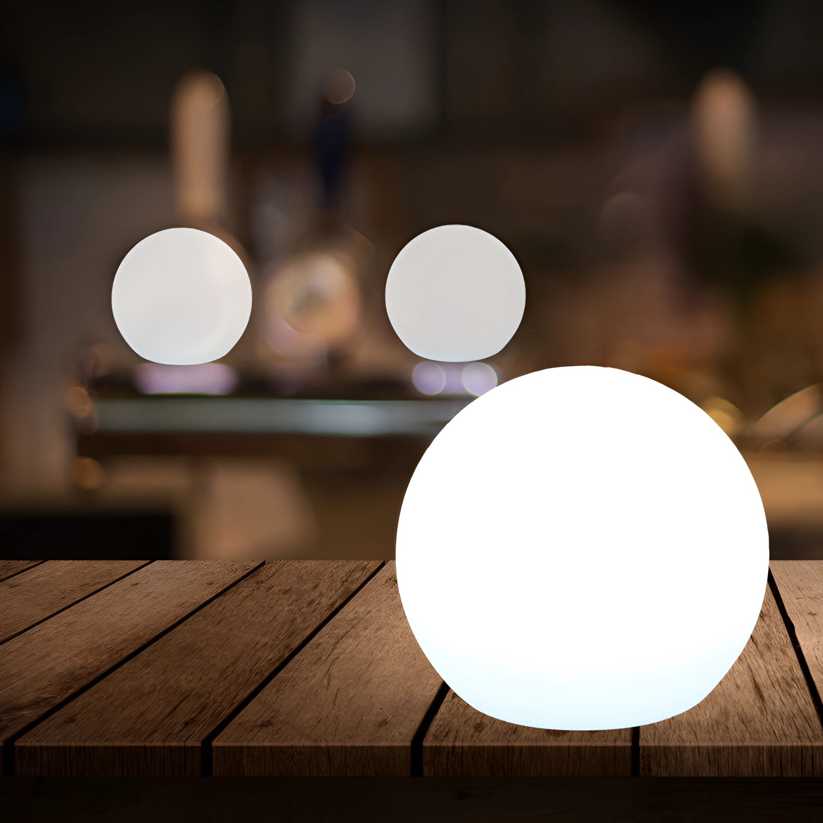 Modern Minimalist LED Globe Lamp with wooden base, emitting a soft warm light, rechargeable and cordless, perfect for bedside use.