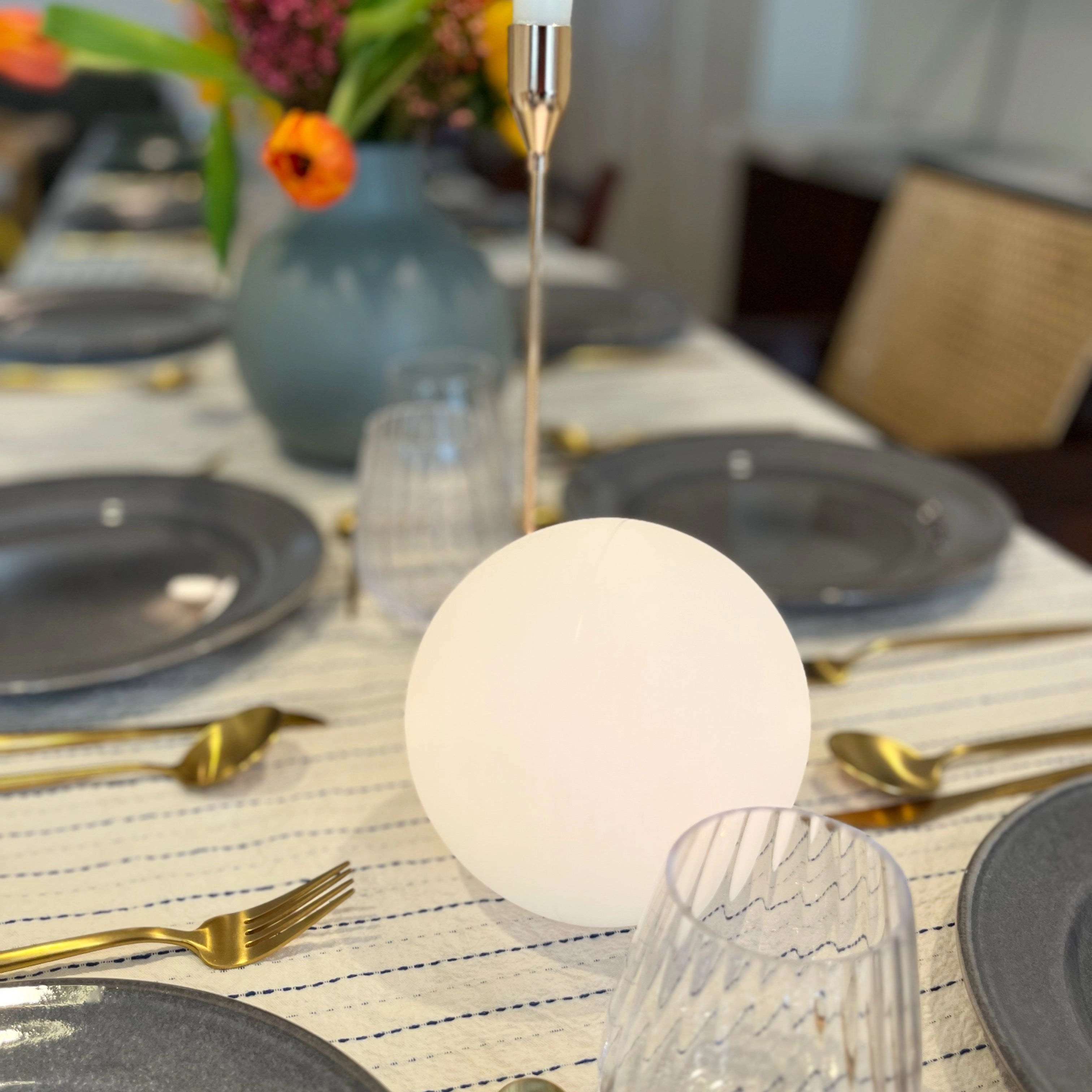 Modern Minimalist LED Globe Lamp on a bedside table with a houseplant and decorative tableware.