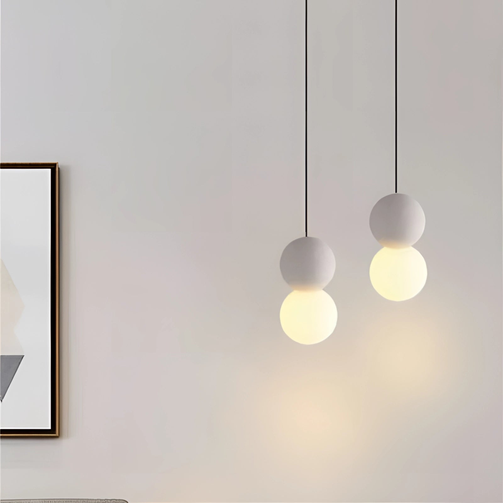 Modern minimalist LED pendant light with a black and gray spherical design, featuring a sleek ceiling fixture against a neutral-toned ceiling background.