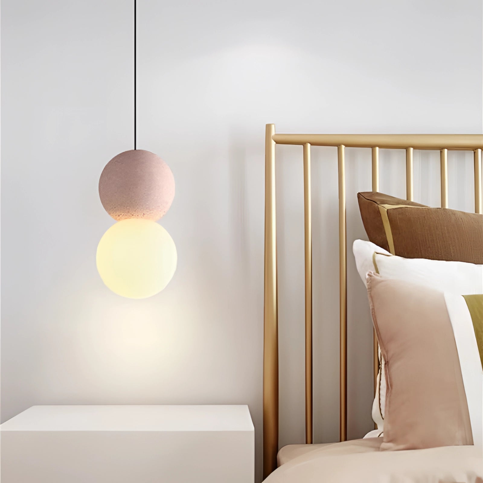 Modern minimalist LED pendant light featuring a black and gray spherical fixture with a pink and natural white color scheme, elegantly suspended in a contemporary interior setting.