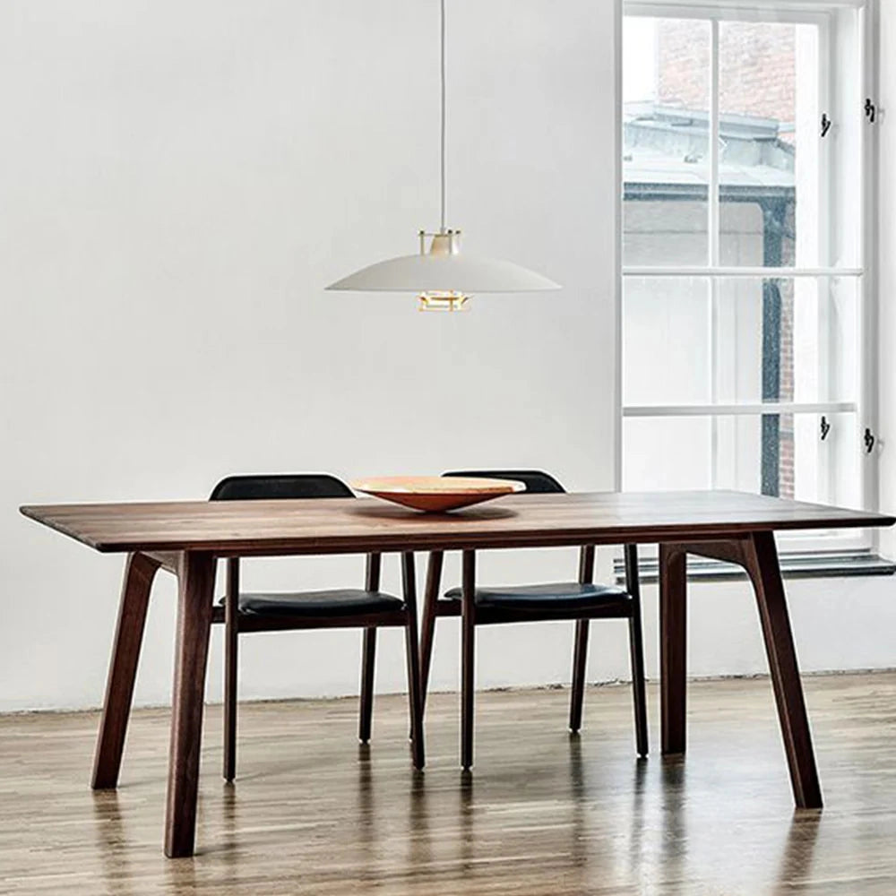 Modern minimalist LED pendant light with a Scandinavian white fixture hanging above a wooden table and chairs in a contemporary interior setting.